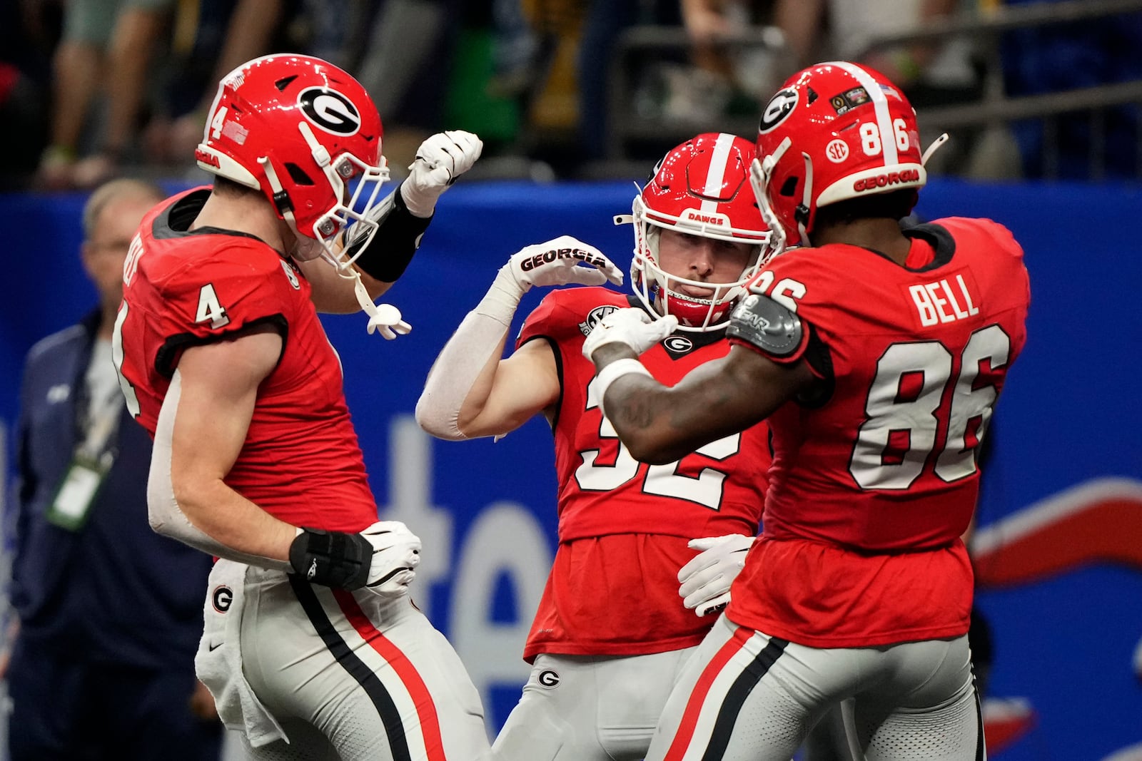 Georgia running back Cash Jones (32) celebrates with teammates Oscar Delp (4) and Dillon Bell (86) after catching a 32-yard touchdown pass during the second half against Notre Dame in the quarterfinals of a College Football Playoff, Thursday, Jan. 2, 2025, in New Orleans. (AP Photo/Gerald Herbert)