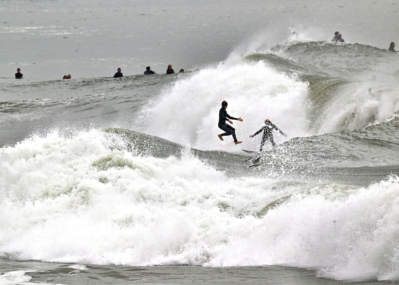 Surfers take to the water as big waves hit the shore in Seal Beach, Calif., Monday, Dec. 23, 2024. (Jeff Gritchen/The Orange County Register via AP)