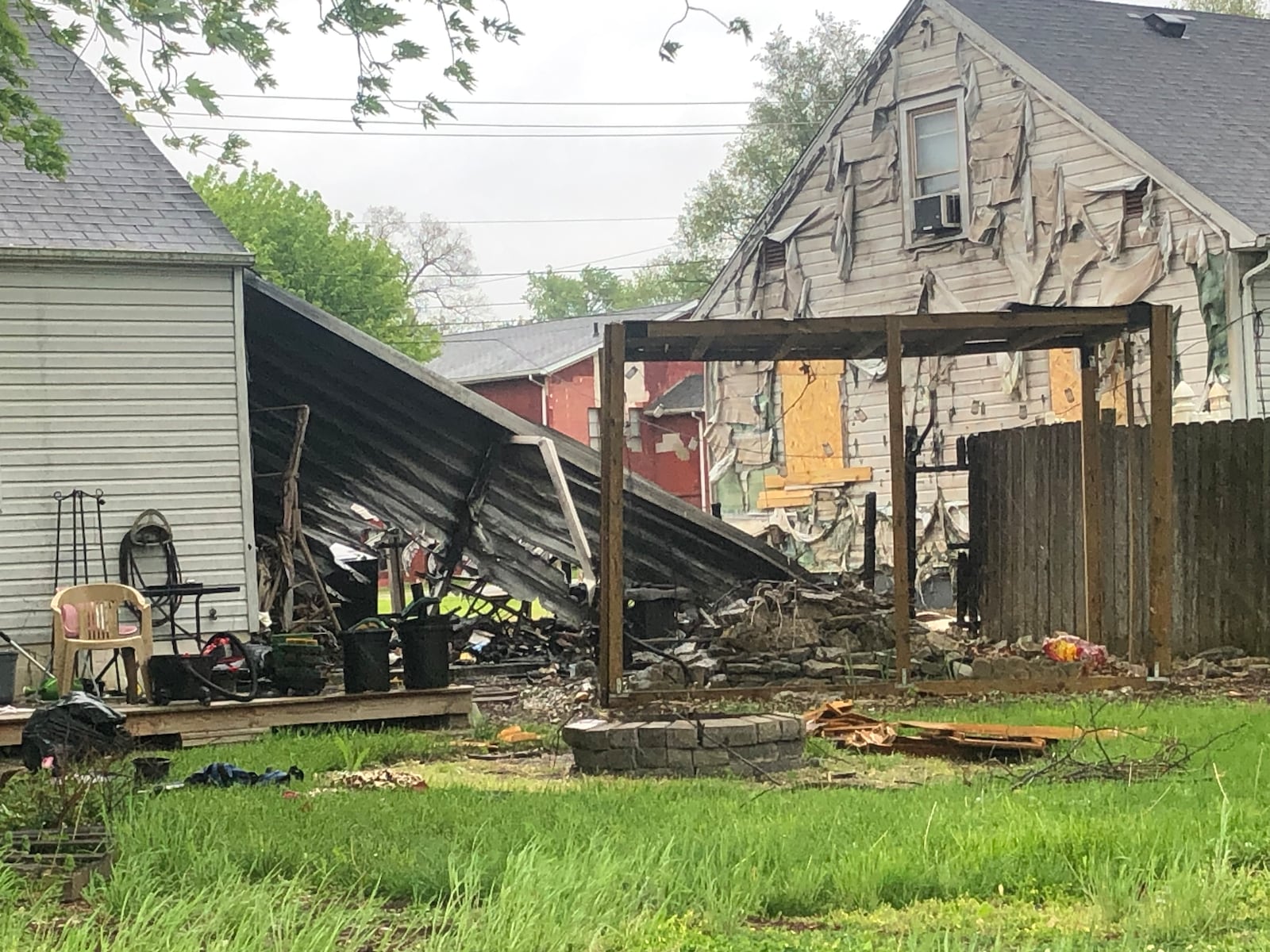 Some of the damage done by a fire Saturday night on Oxford State Road in Middletown is visible from behind the two residences. RICK McCRABB/STAFF