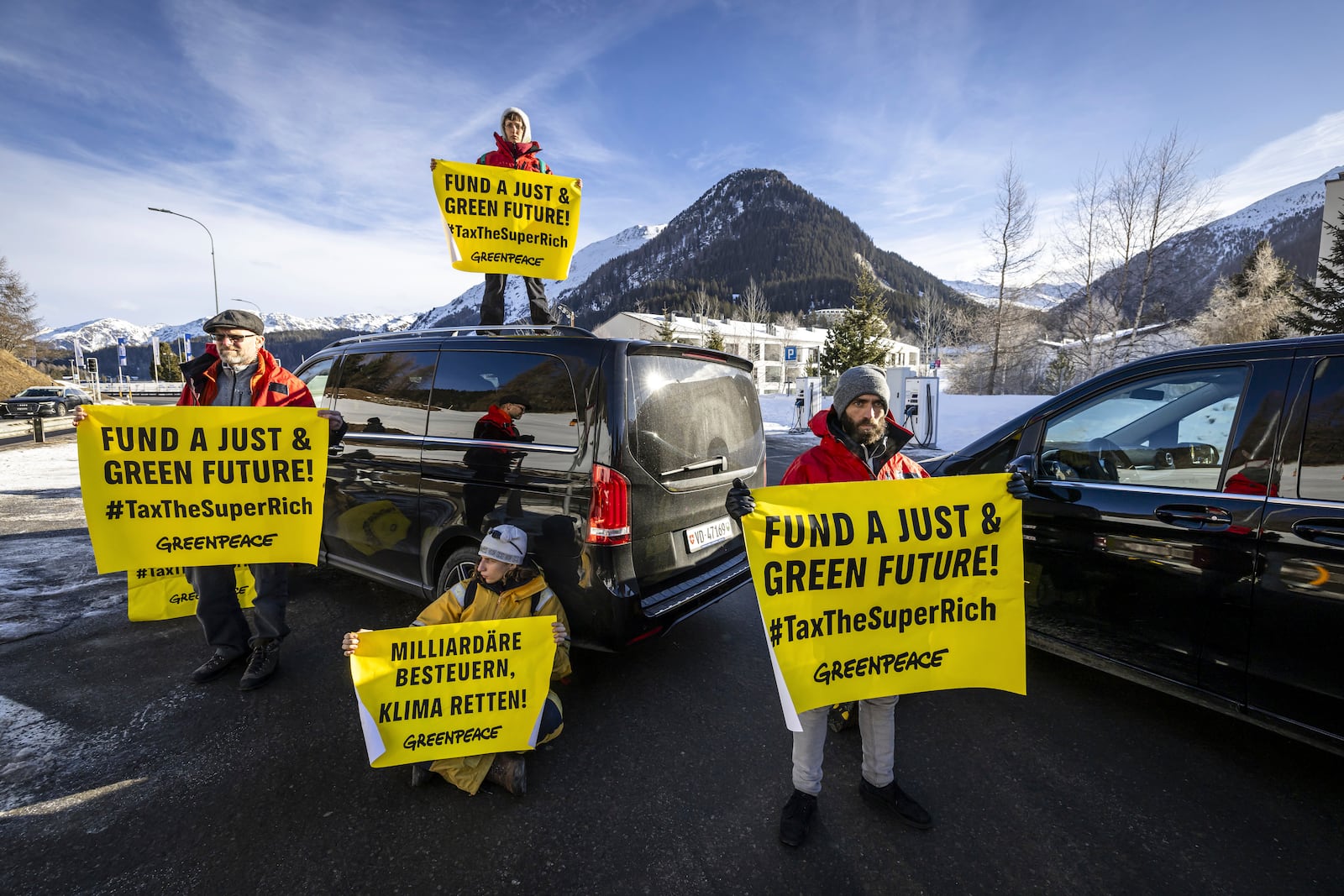 Greenpeace activists block the access road to the heliport during a protest in Davos Dorf during the 55th annual meeting of the World Economic Forum, WEF, in Davos, Switzerland, Monday, Jan. 20, 2025. (Michael Buholzer/Keystone via AP)