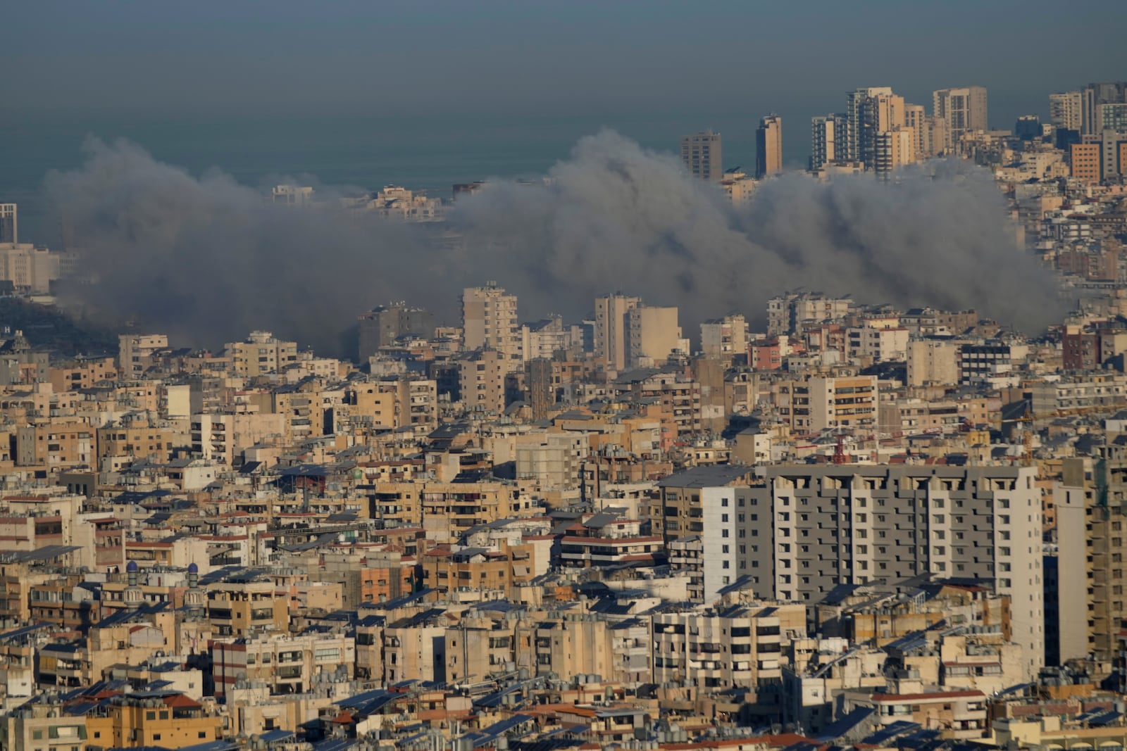 Smoke rises between buildings after an Israeli airstrike in Dahiyeh, in the southern suburb of Beirut, Lebanon, Friday, Nov. 15, 2024. (AP Photo/Hussein Malla)