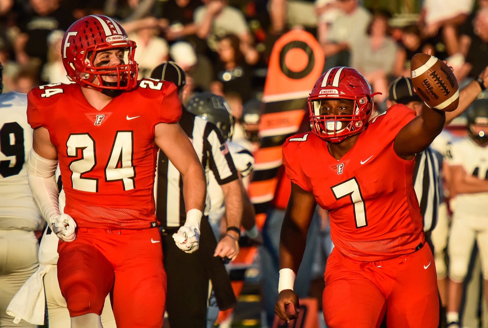 Fairfield’s Malik Vann (7) and Drew Bartolovich celebrate a fumble recovery during Friday night’s game against Lakota East at Fairfield Stadium. NICK GRAHAM/STAFF