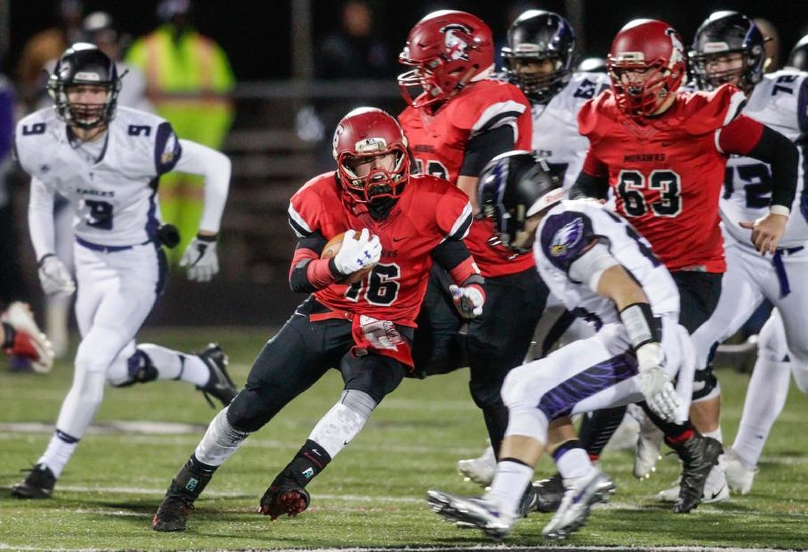 Madison’s Tyler Baumgartner (16) looks for running room against Cincinnati Hills Christian Academy on Friday night during a Division V, Region 20 semifinal at Lakota East. NICK GRAHAM/STAFF