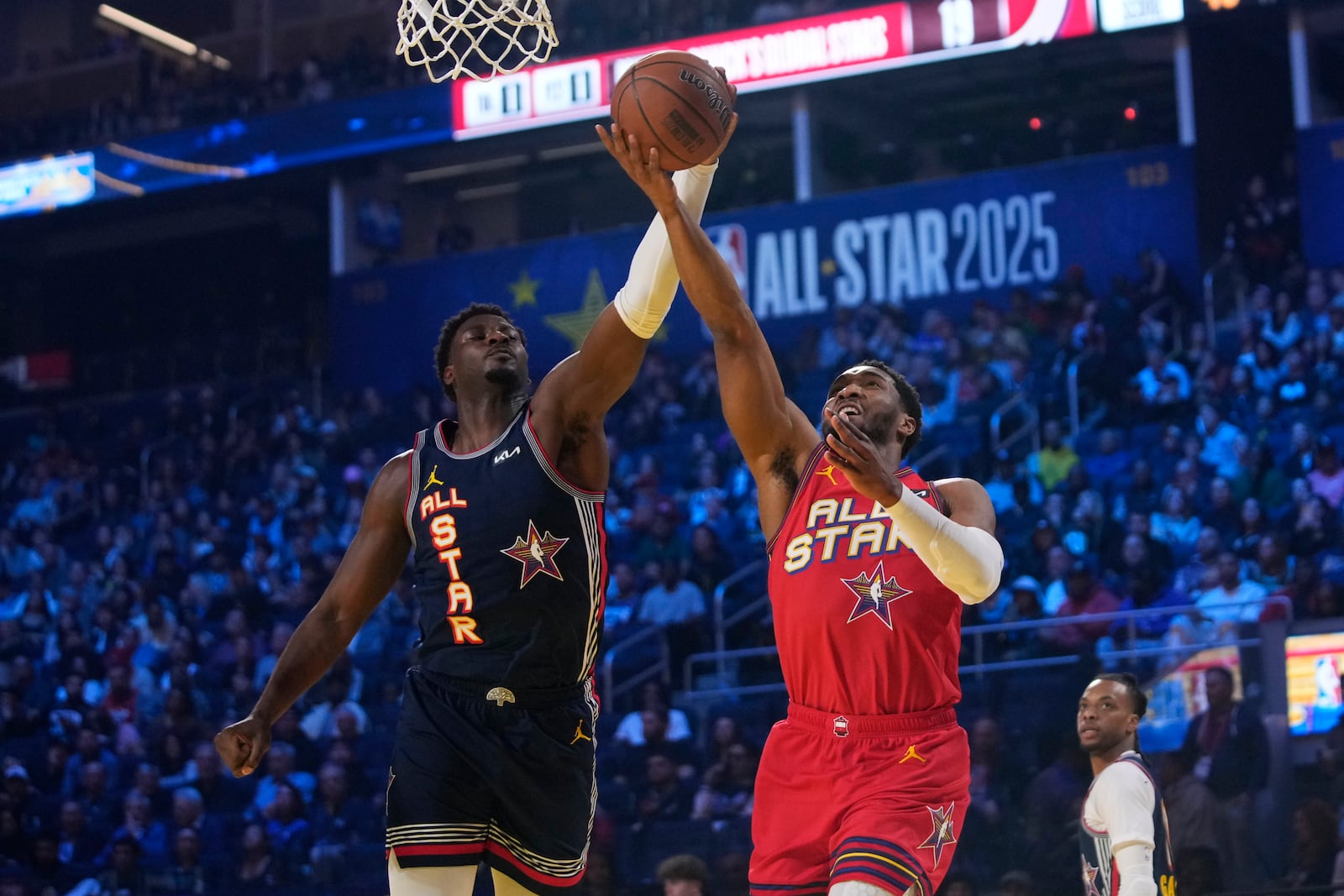 Cleveland Cavaliers guard Donovan Mitchell, right, drives to the basket as Memphis Grizzlies forward Jaren Jackson Jr. defends during the NBA All-Star basketball game Sunday, Feb. 16, 2025, in San Francisco. (AP Photo/Godofredo A. Vásquez)