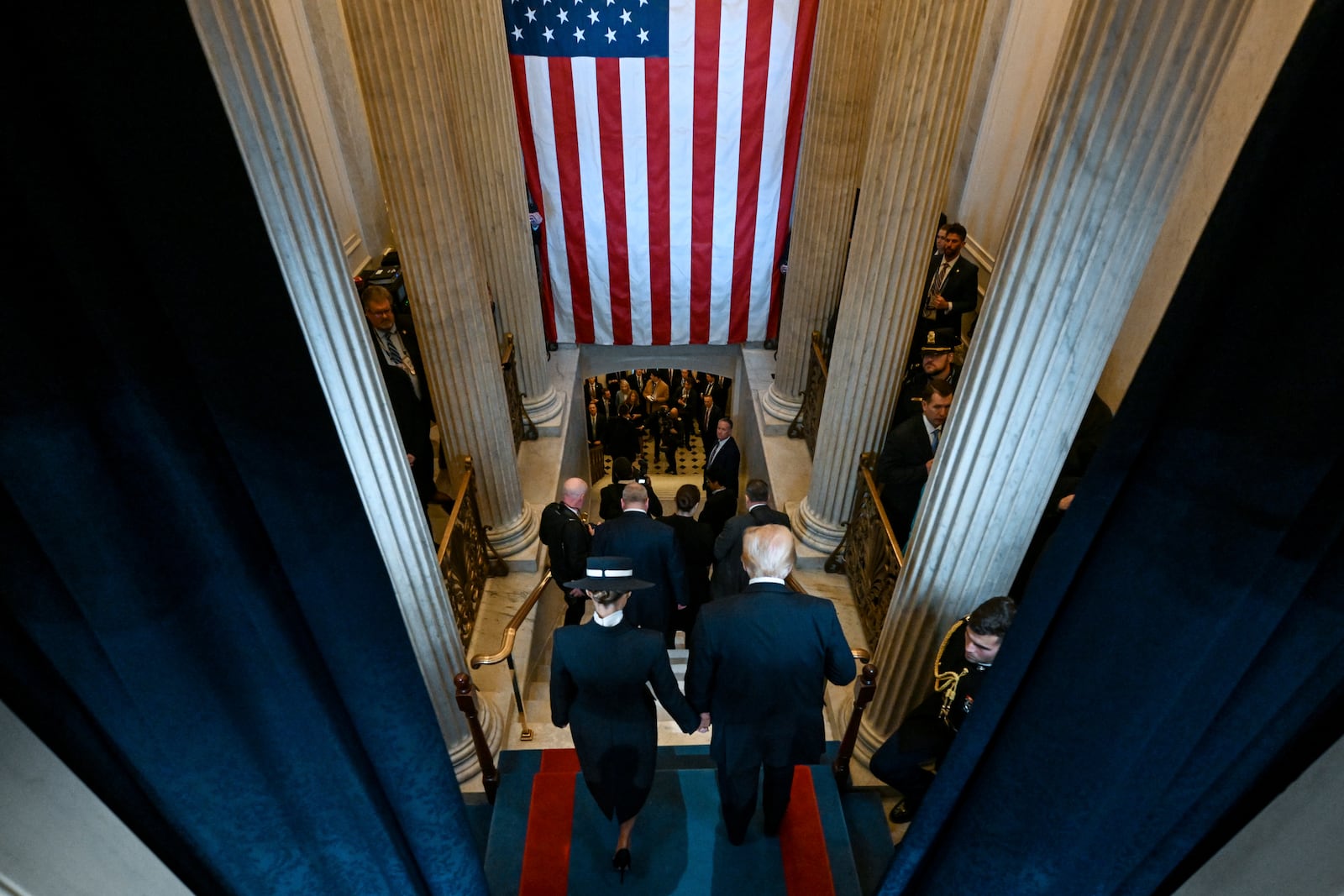 President Donald Trump, right, and first lady Melania Trump depart after the 60th Presidential Inauguration in the Rotunda of the U.S. Capitol in Washington, Monday, Jan. 20, 2025. (Kenny Holston/The New York Times via AP, Pool)