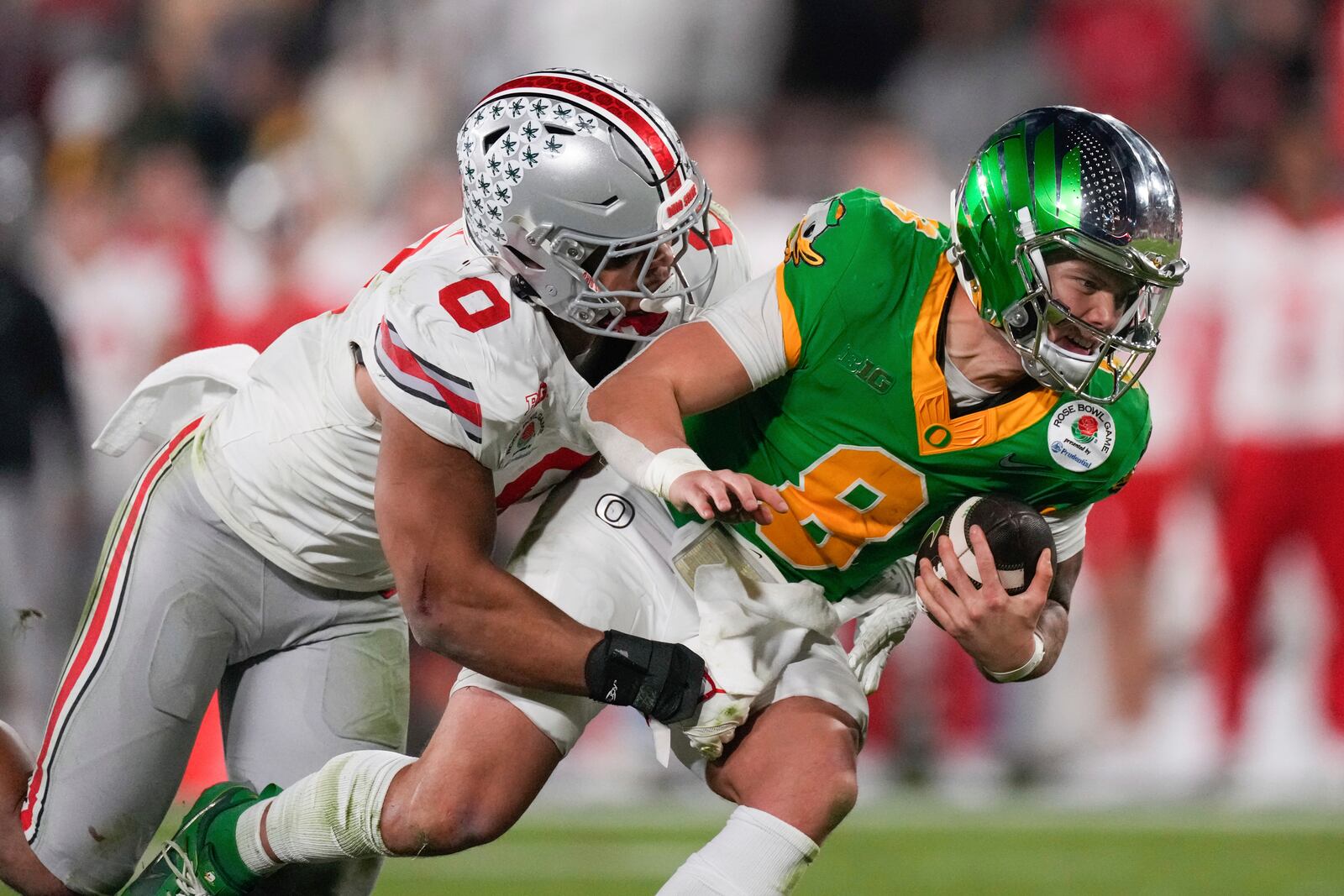 Ohio State linebacker Cody Simon (0) sacks Oregon quarterback Dillon Gabriel (8) during the second half in the quarterfinals of the Rose Bowl College Football Playoff, Wednesday, Jan. 1, 2025, in Pasadena, Calif. (AP Photo/Mark J. Terrill)