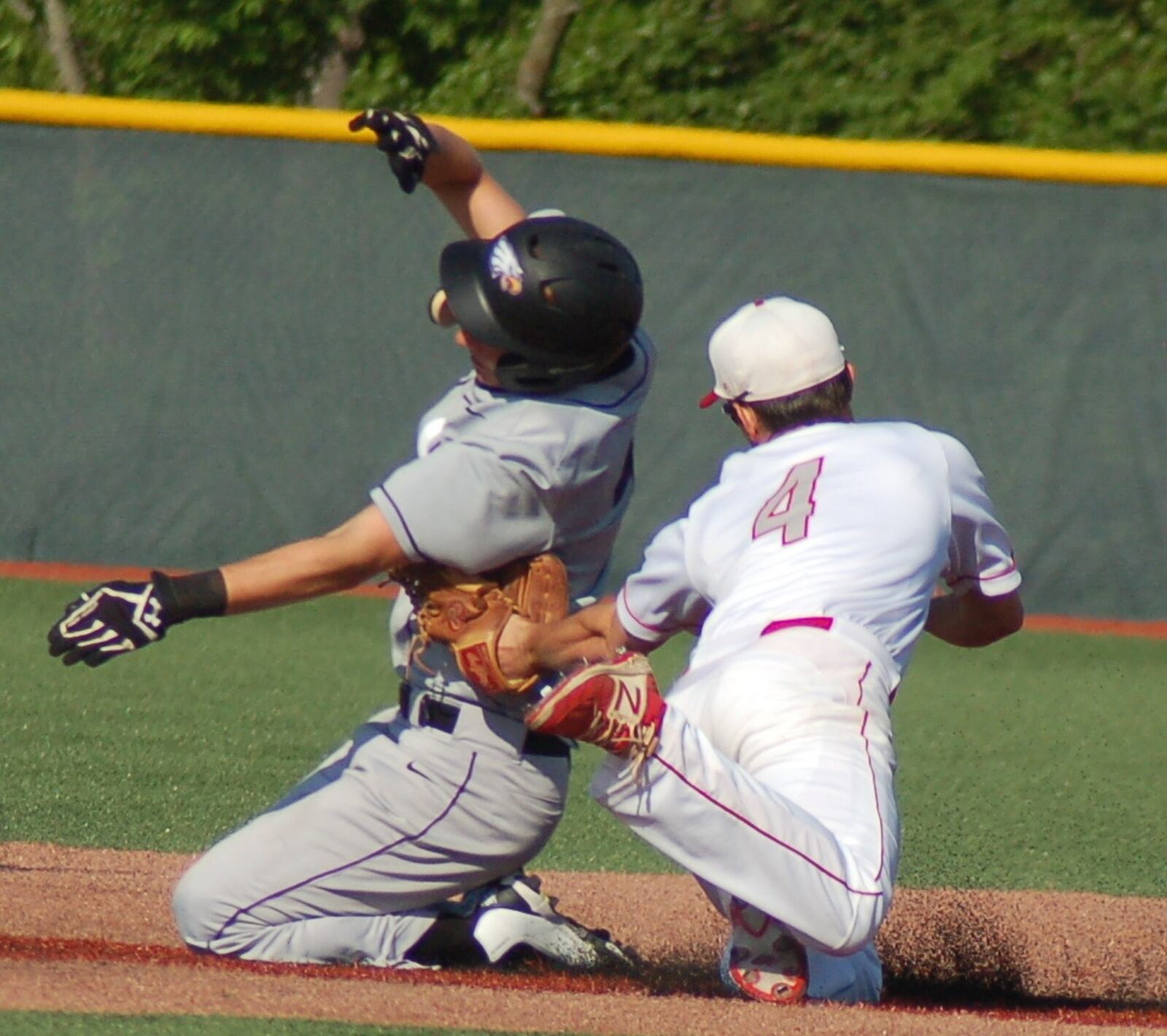 Carlisle shortstop Adam Goodpaster puts a tag on Cincinnati Hills Christian Academy’s Adam Rakestraw during Friday’s Division III regional final at the Athletes in Action complex in Xenia. CONTRIBUTED PHOTO BY JOHN CUMMINGS