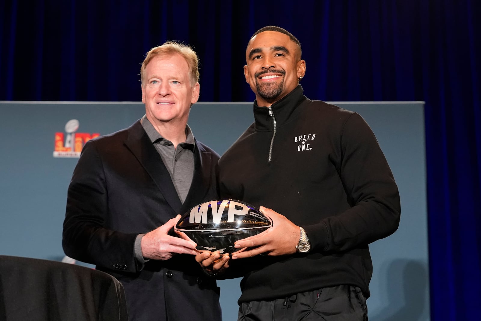 Philadelphia Eagles quarterback Jalen Hurts, right, poses with the Pete Rozelle MVP trophy with NFL commissioner Roger Goodell during a news conference the morning after Super Bowl 59 between the Eagles and the Kansas City Chiefs, Monday, Feb. 10, 2025, in New Orleans. (AP Photo/Gerald Herbert)