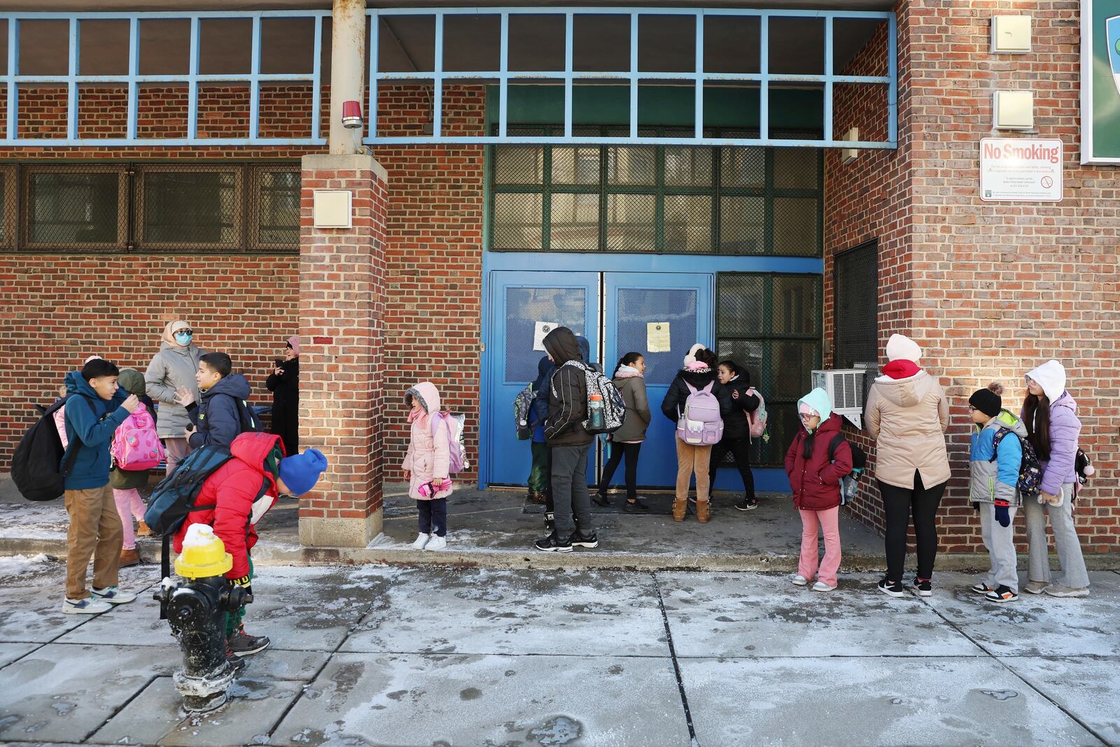 Students arrive for school Tuesday, Jan. 21, 2025, in the East Boston neighborhood of Boston. (AP Photo/Michael Dwyer)