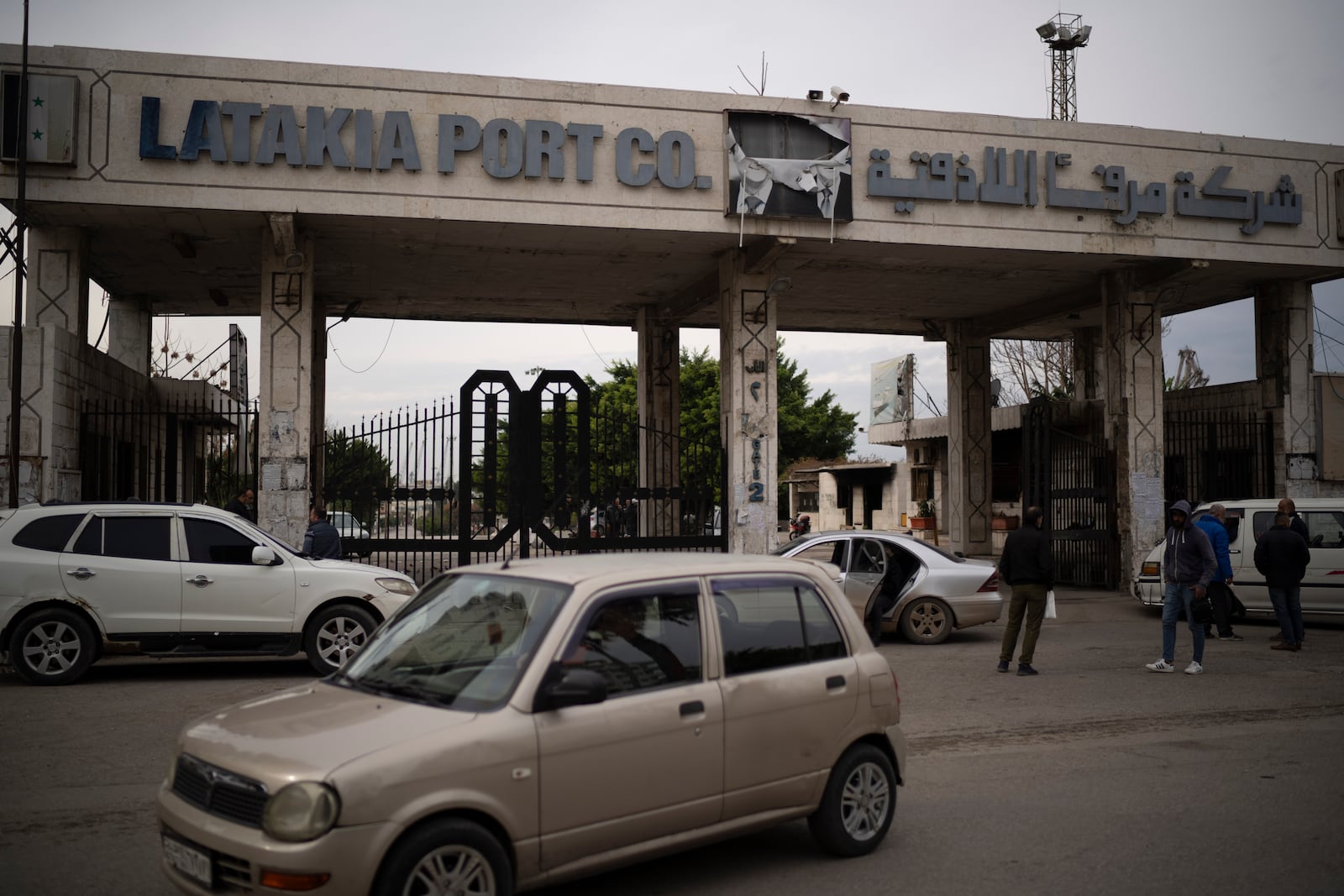 A car drives past the entrance of the port of Latakia, Syria, Monday, Dec. 16, 2024. (AP Photo/Leo Correa)