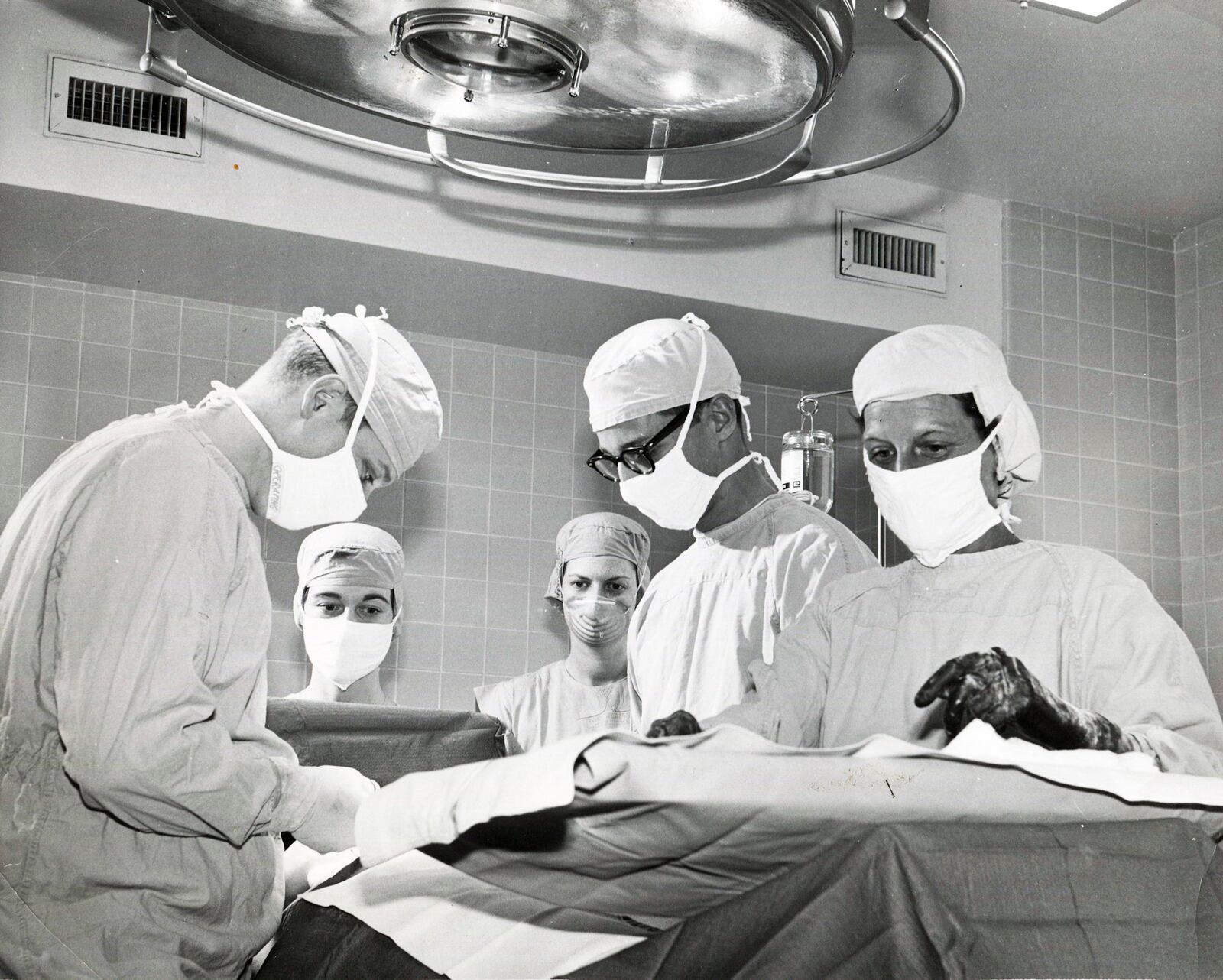 A group of surgeons operate on a patient in the early 1960s. The hospital is celebrating its 90th anniversary this year.