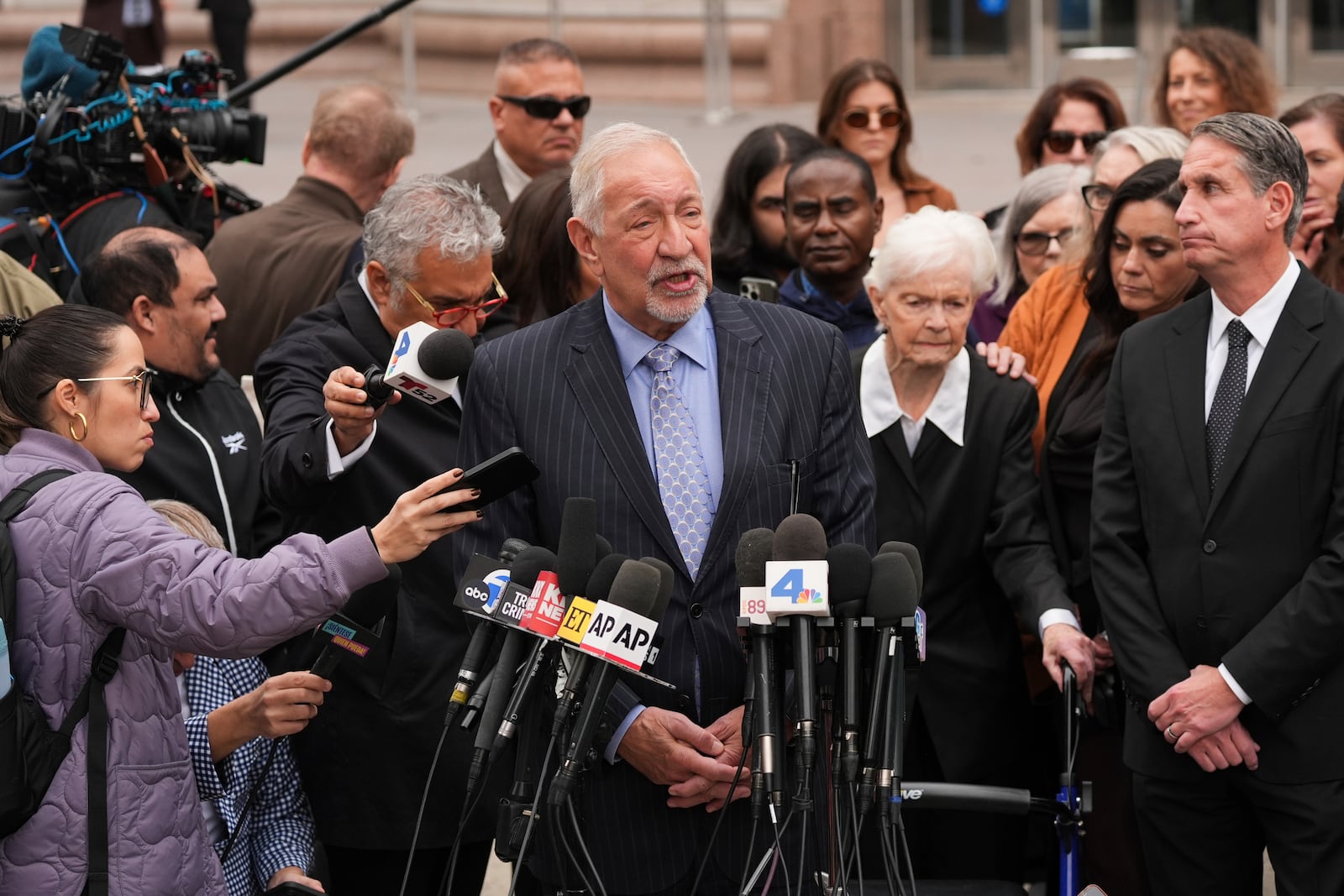 Joined by family members of Erik and Lyle Menendez, attorney Mark Geragos, center, speaks during a news conference after a hearing in Los Angeles, Monday, Nov. 25, 2024. (AP Photo/Jae C. Hong)