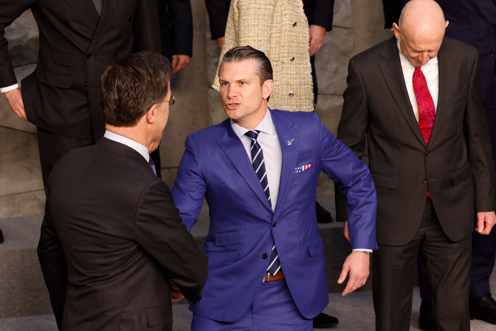 United States Secretary of Defense Pete Hegseth, center, speaks with NATO Secretary General Mark Rutte during a group photo of NATO defense ministers at NATO headquarters in Brussels, Thursday, Feb. 13, 2025. (AP Photo/Geert Vanden Wijngaert)