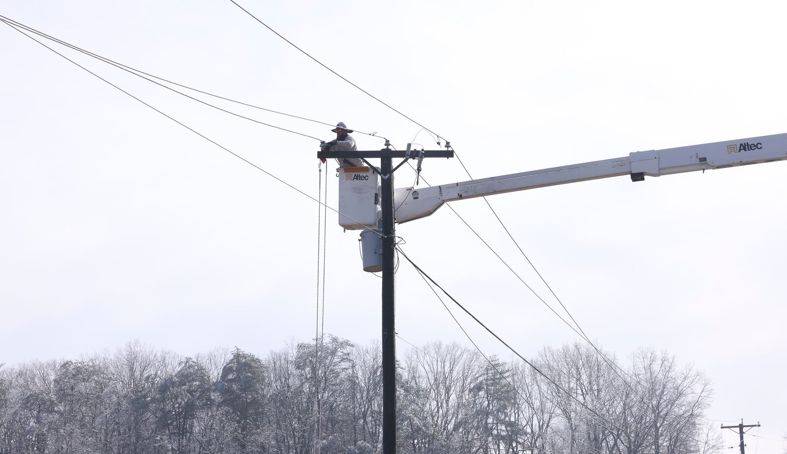 Utility crews work on power lines after a winter storm blanketed the area Thursday, Feb. 13, 2025, Franklin County, Va. (Heather Rousseau