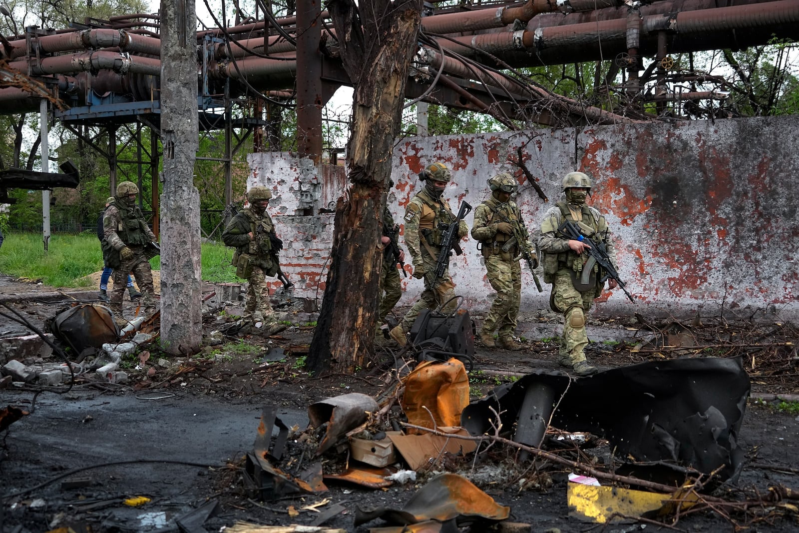 FILE - Russian troops walk in a destroyed part of the Illich Iron & Steel Works Metallurgical Plant in Mariupol, in territory under the government of the Donetsk People's Republic, eastern Ukraine, May 18, 2022. (AP Photo, File)