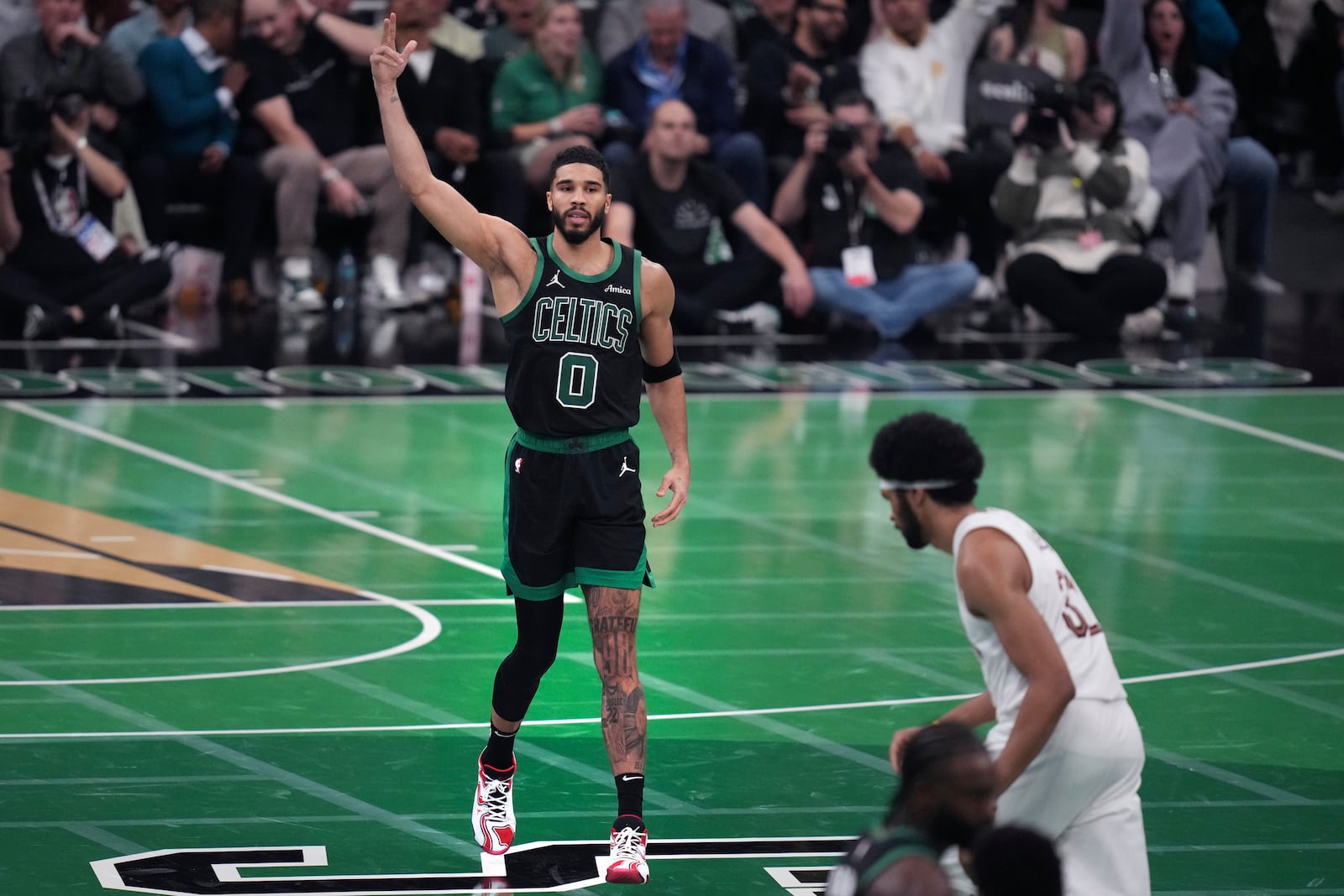 Boston Celtics forward Jayson Tatum (0) celebrates after hitting a 3-pointer during the second half of an Emirates NBA Cup basketball game against the Cleveland Cavaliers, Tuesday, Nov. 19, 2024, in Boston. (AP Photo/Charles Krupa)