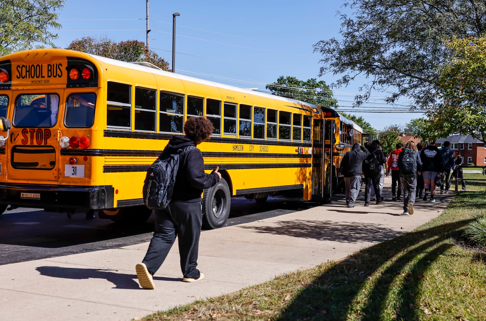 Students exit to buses at Hamilton High School at the end of the school day Thursday, Oct. 3, 2024 in Hamilton. NICK GRAHAM/STAFF