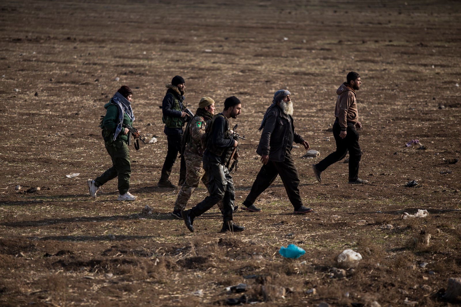 FILE - Kurdish-led fighters backed by the U.S. escort suspected Islamic State militants in Hassakeh, Syria, on Jan. 26, 2022. (AP Photo/Baderkhan Ahmad, File)