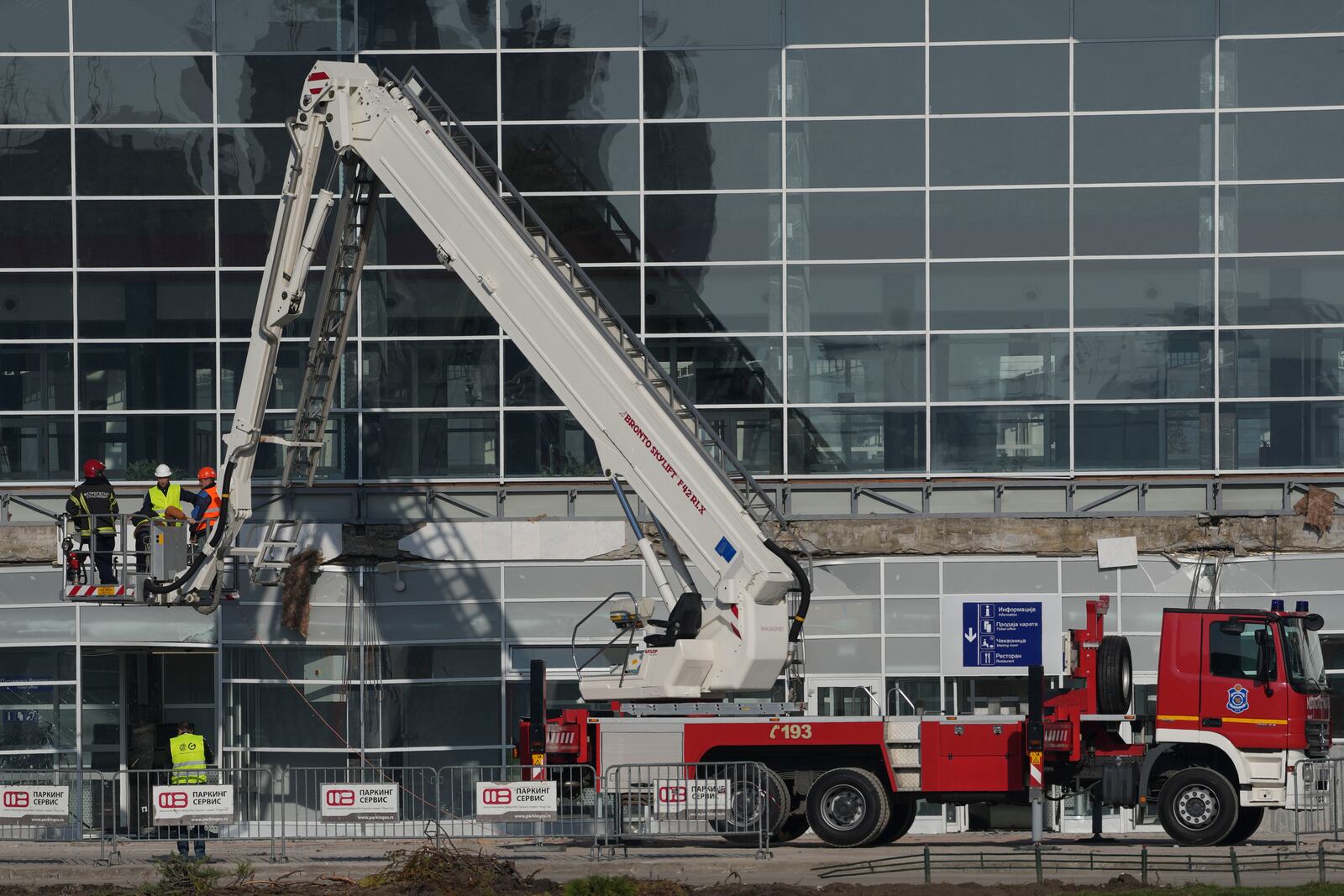 Workers inspect a train station after an outdoor roof collapsed on Friday, in Novi Sad, Serbia, Saturday, Nov. 2, 2024. (AP Photo/Darko Vojinovic)