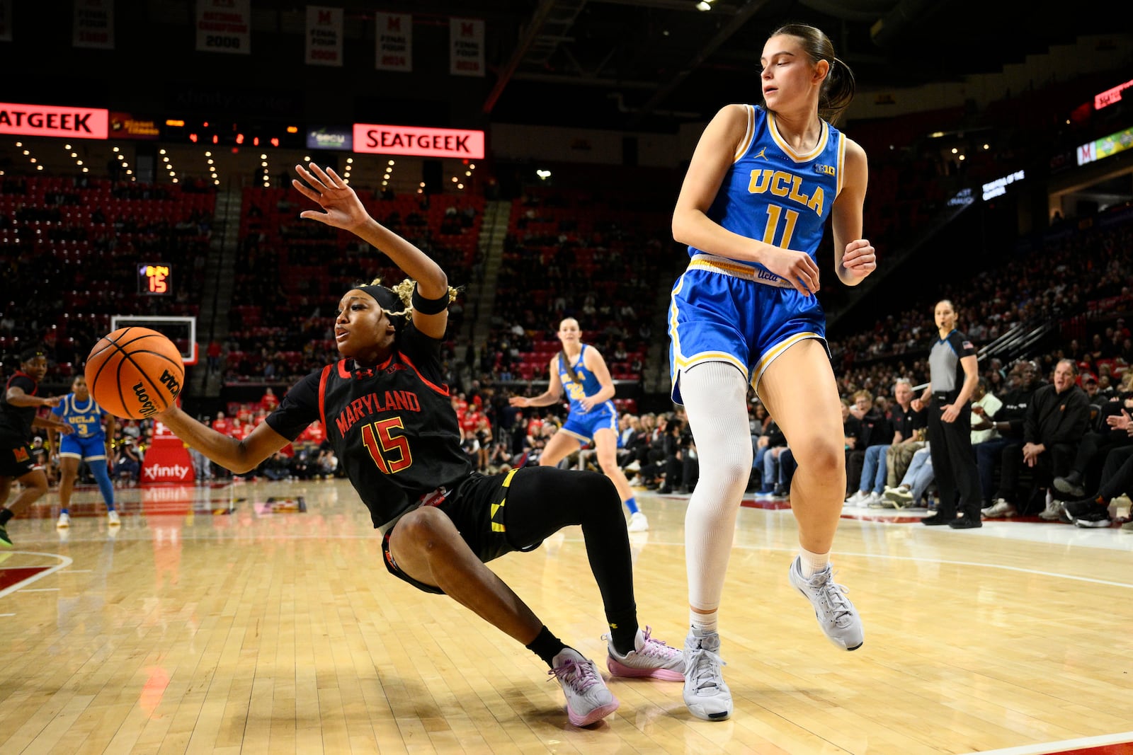 Maryland forward Christina Dalce (15) falls after she was fouled by UCLA guard Gabriela Jaquez (11) during the first half of an NCAA college basketball game, Sunday, Jan. 26, 2025, in College Park, Md. (AP Photo/Nick Wass)