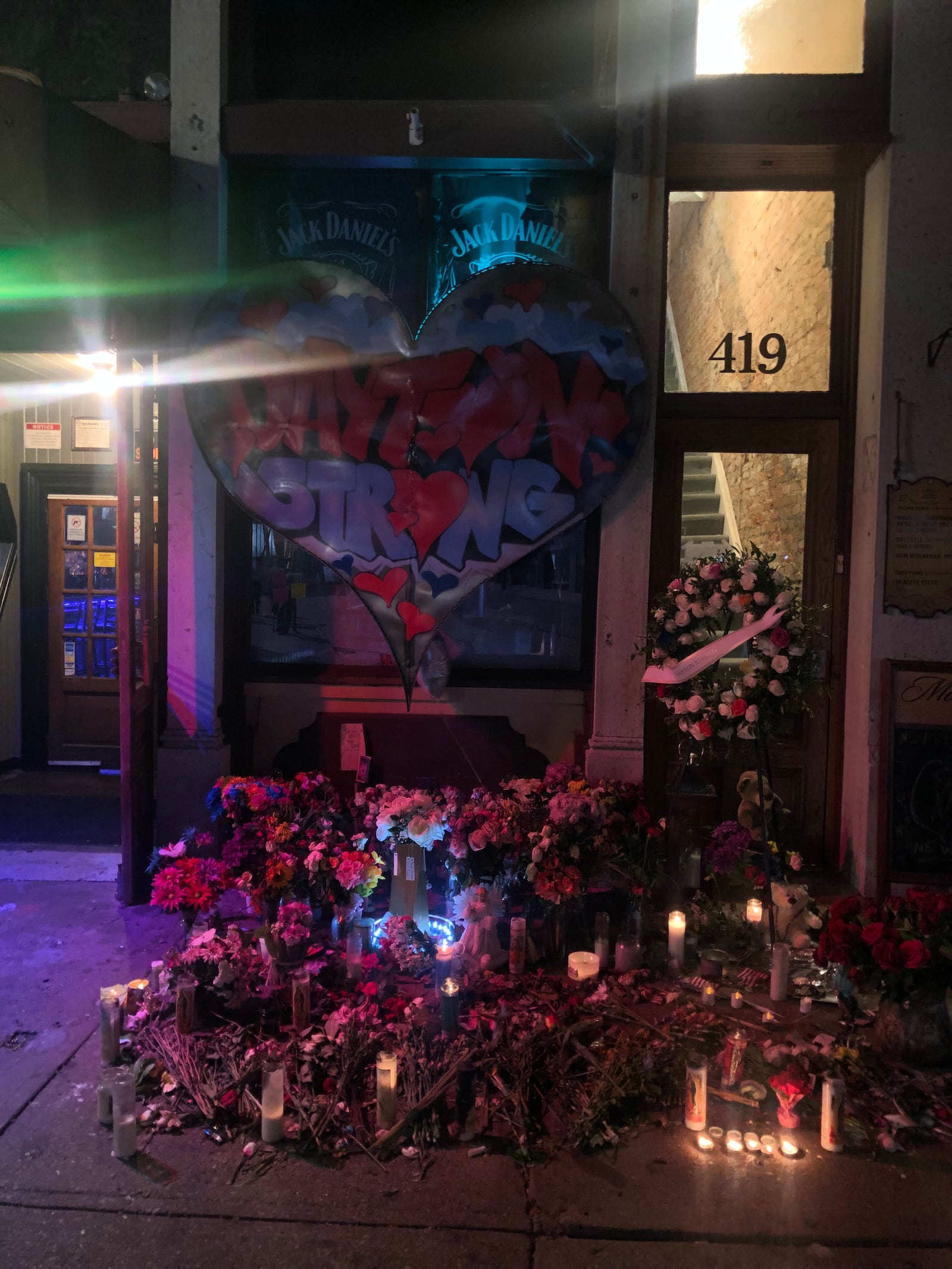 Flowers and candles visible outside Ned Peppers in the Oregon District in Dayton on Tuesday, Aug. 6. A mass shooting that killed nine people and injured 27 others took place in the Oregon District outside the bar. AMELIA ROBINSON/STAFF