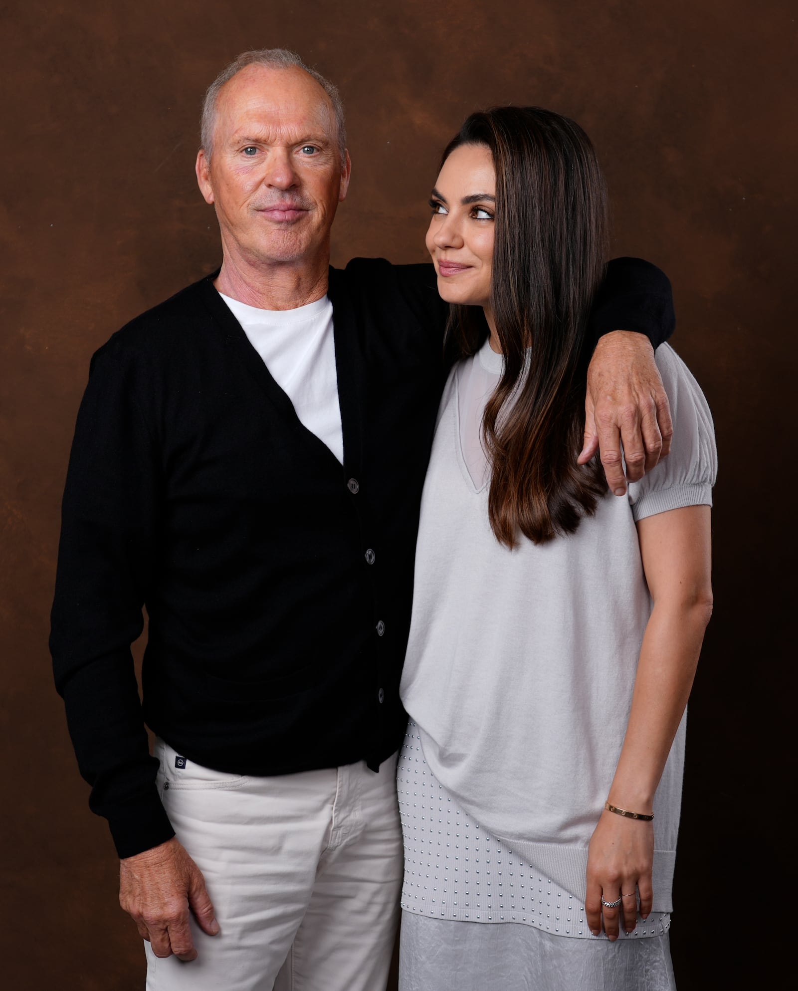 Michael Keaton, left, and Mila Kunis, cast members in the film "Goodrich," pose together for a portrait, Tuesday, Oct. 8, 2024, in Los Angeles. (AP Photo/Chris Pizzello)