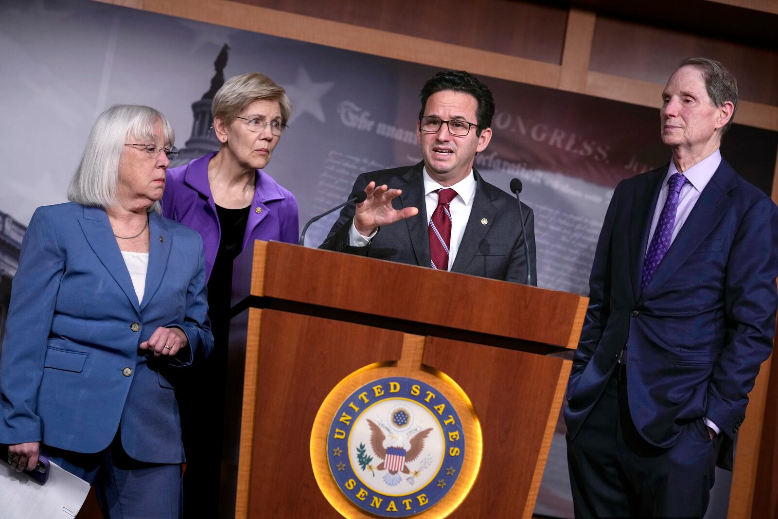 Sen. Brian Schatz, D-Hawaii, speaks as Sen. Patty Murray, D-Wash., from left, Sen. Elizabeth Warren, D-Mass., and Sen. Ron Wyden, D-Ore., ranking member of the Senate Finance Committee, listen during a news conference about the Department of Government Efficiency, or DOGE, at the Capitol in Washington, Monday, Feb. 3, 2025. (AP Photo/J. Scott Applewhite)