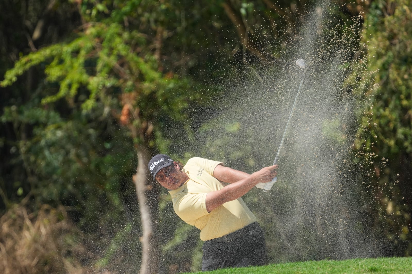 Aldrich Potgieter, of South Africa, watches his hit from the sand on the second hole during the final round of the Mexico Open golf tournament in Puerto Vallarta, Mexico, Sunday, Feb. 23, 2025. (AP Photo/Fernando Llano)