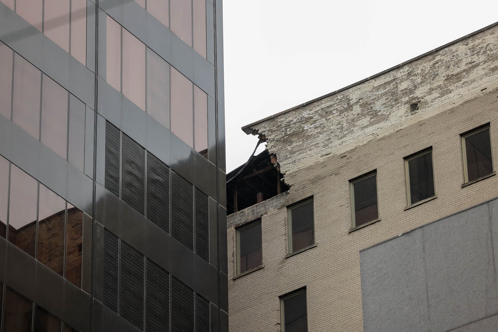 A view of a building that neighbors Stratacache Tower on Main Street. Some of the building's facade reportedly fell off and hit Stratacache Tower. The Dayton Fire Department blocked off Main Street and also blocked off an alley between North Jefferson Street and Main Street. BRYANT BILLING/STAFF