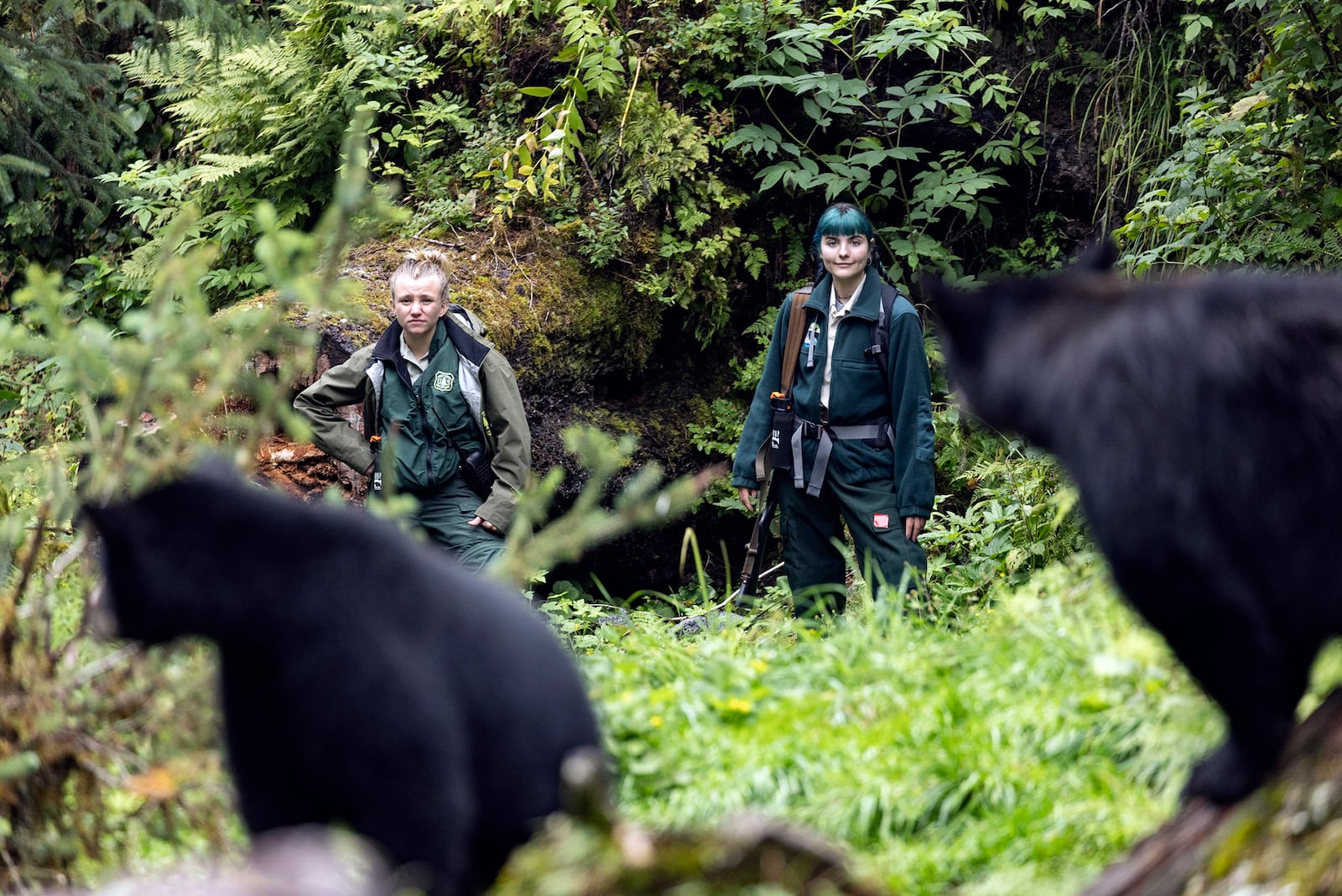 This photo provided by Nathaniel Wilder shows Kayleigh McCarthy, left, keeping an eye on bears at the Anan Wildlife Observatory near Wrangell, Alaska, Aug. 9, 2021. (Nathaniel Wilder via AP)