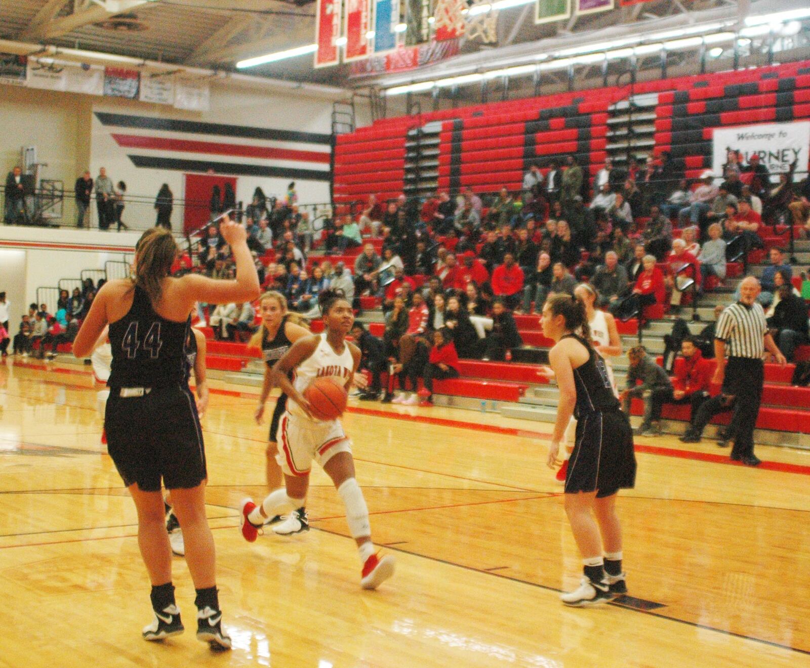 Lakota West’s Chance Gray (2) drives to the basket between Northwestern defenders Kendall Bostic (44) and Sarah Heaver (13) on Saturday night at West. The host Firebirds earned a 61-53 victory in the Journey to the Tourney event. RICK CASSANO/STAFF