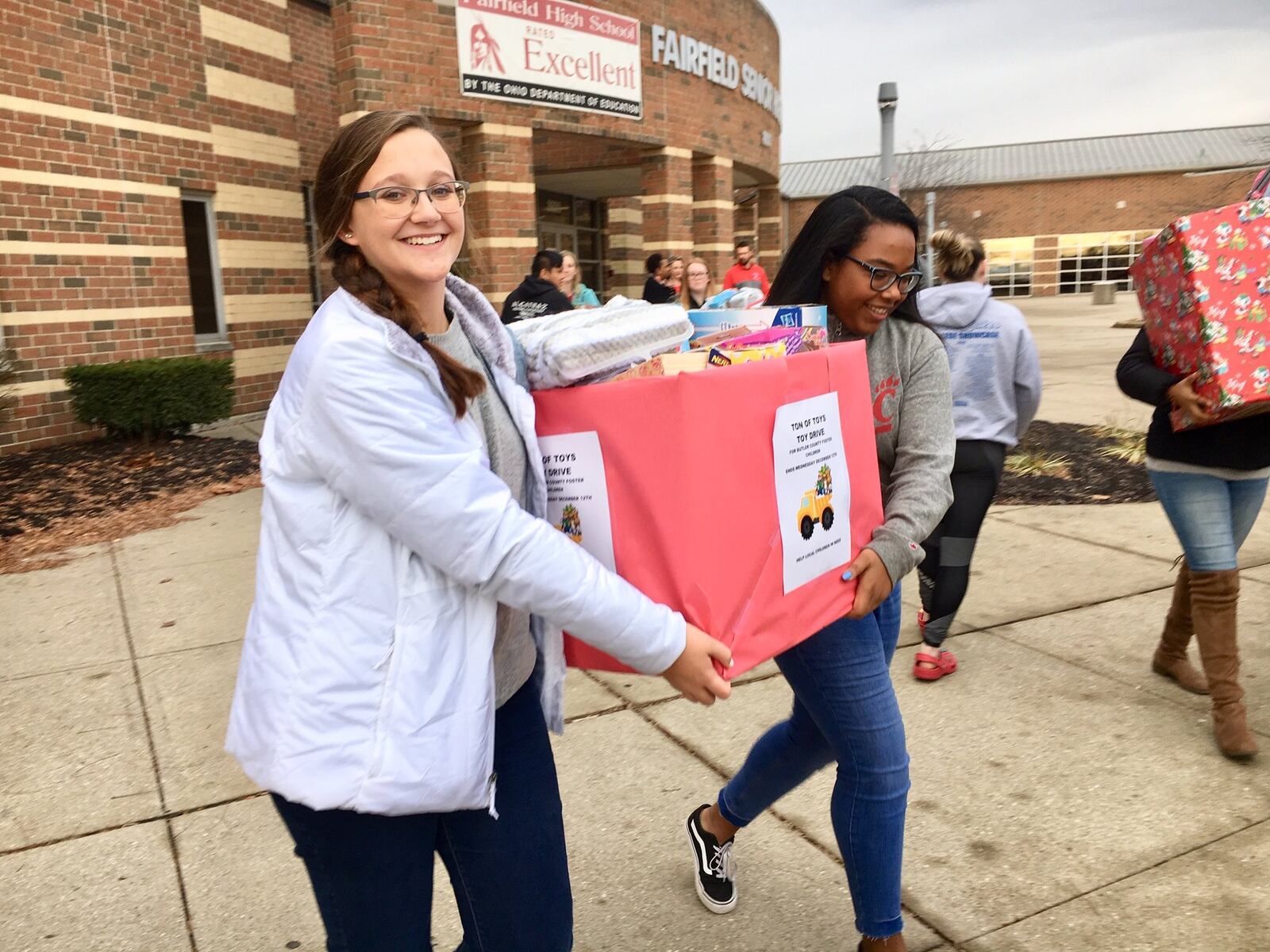 Students from Fairfield High School carry boxes of donated Christmas toys they sorted earlier for area foster children into a giant truck outside the Butler County school. The volunteering students are part of Students Against Distracted Driving and they are helping spread holiday cheer for foster kids through the county’s Children’s Services Agency. The annual gift drive collected 1,496 gifts this year.