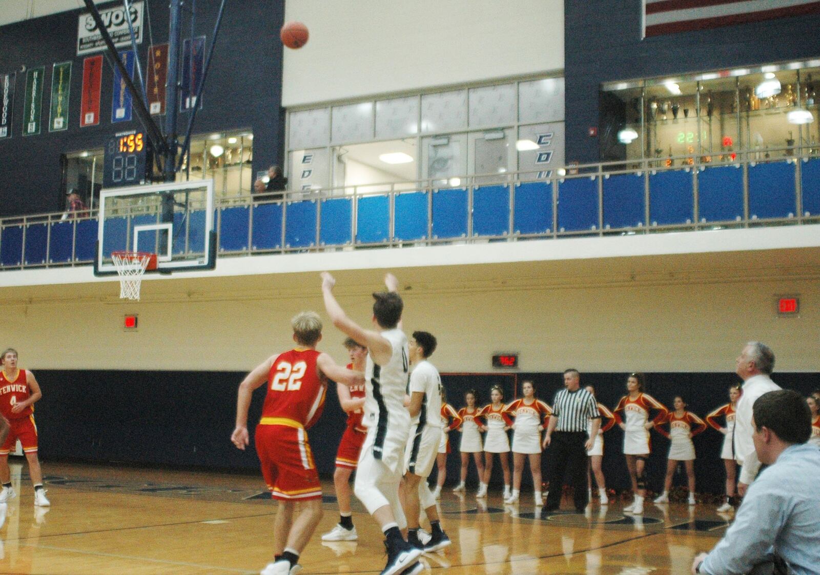 Edgewood’s Johnathan Shepherd (0) launches a 3-point attempt while Fenwick’s C.J. Napier (22) watches the flight of the ball Tuesday night at Ron Kash Court in St. Clair Township. That’s Fenwick coach Pat Kreke standing to the right, and his Falcons won 48-38. RICK CASSANO/STAFF