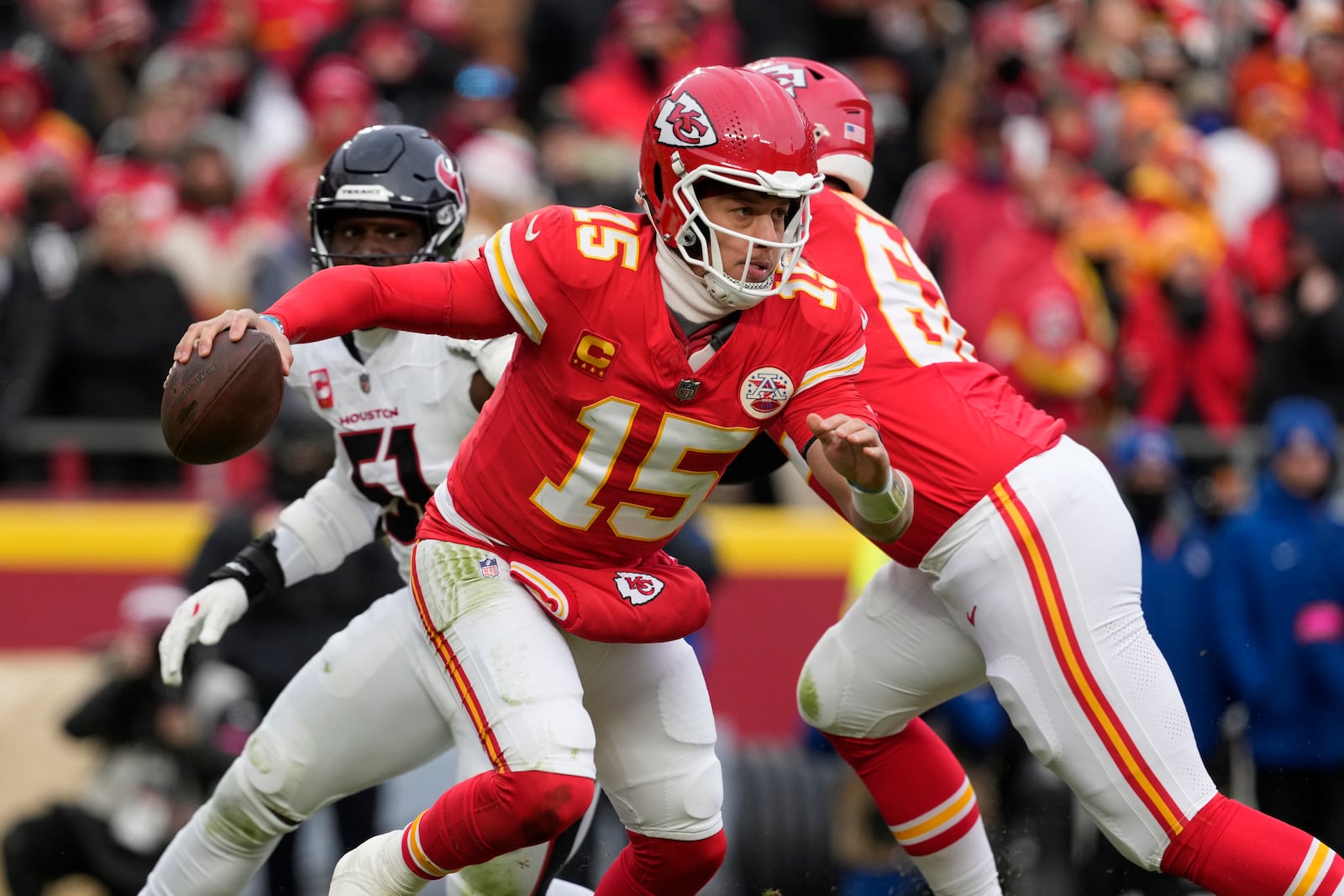 Kansas City Chiefs quarterback Patrick Mahomes (15) scrambles during the first half of an NFL football AFC divisional playoff game against the Houston Texans Saturday, Jan. 18, 2025, in Kansas City, Mo. (AP Photo/Ed Zurga)