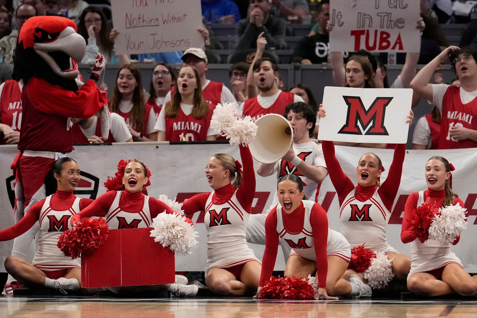 Miami cheerleaders shout in the second half of an NCAA college basketball game against Akron in the championship of the Mid-American Conference tournament, Saturday, March 15, 2025, in Cleveland, Ohio. (AP Photo/Sue Ogrocki)