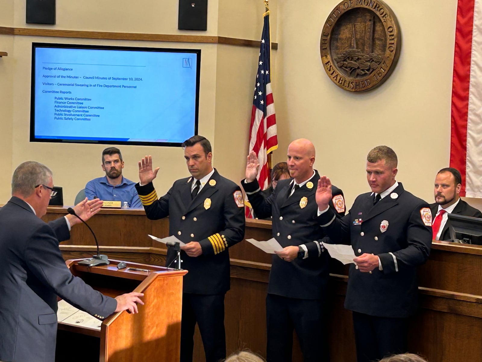 Monroe Law Director Philip Callahan performs a swearing in ceremony of three members of the Monroe fire department who were recently promoted during a City Council meeting. From left: Assistant Fire Chief Steve Sarver, Battalion Chief Zach Bernard and Lt. Joe Carey. RICK McCRABB/CONTRIBUTOR