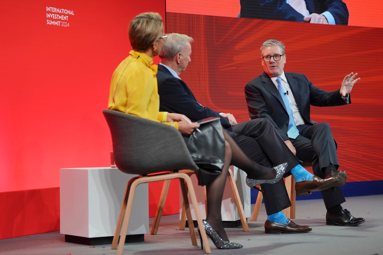 British Prime Minister Keir Starmer, right, sits in conservation with former CEO of Google, Eric Schmidt, center, and Emma Walmsley the CEO of GSK, during the International Investment Summit in London, Monday, Oct. 14, 2024. (Jonathan Brady/Pool Photo via AP)