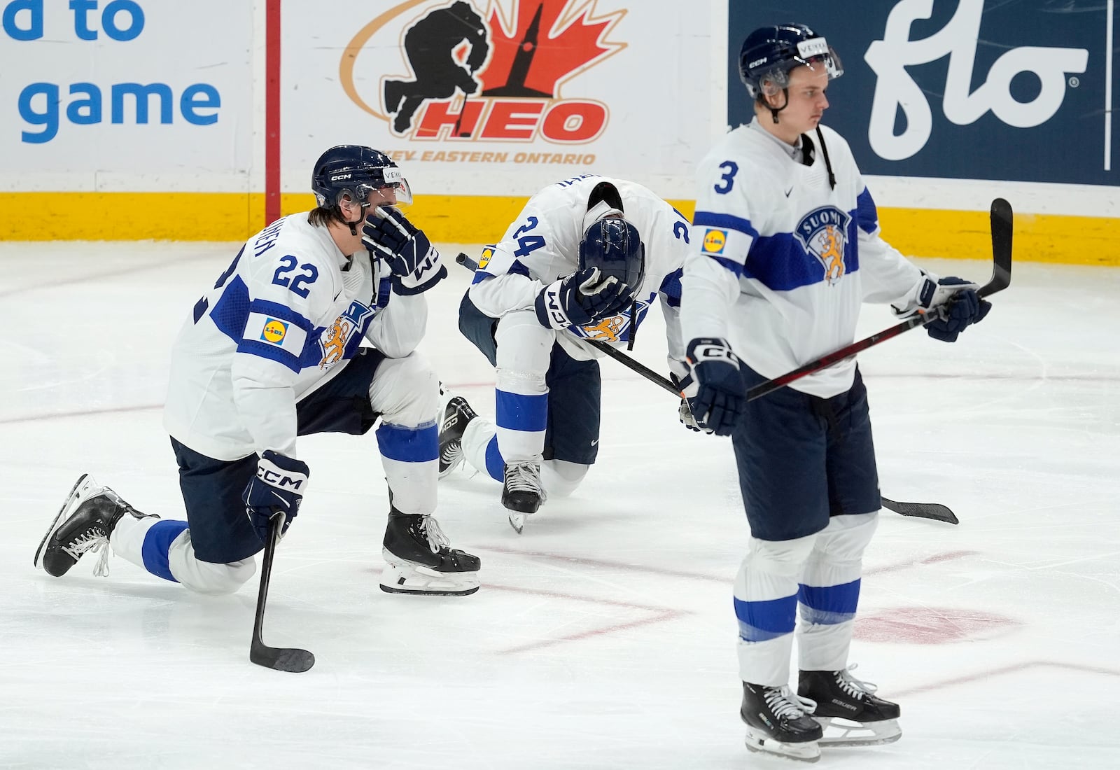 Finland forward Kasper Halttunen (22) with teammates Jesse Nurmi (24) and Kalle Kangas (3) react after their overtime loss to the United States in the IIHF World Junior Hockey Championship gold medal game in Ottawa, Ontario, Sunday, Jan. 5, 2025. (Adrian Wyld/The Canadian Press via AP)