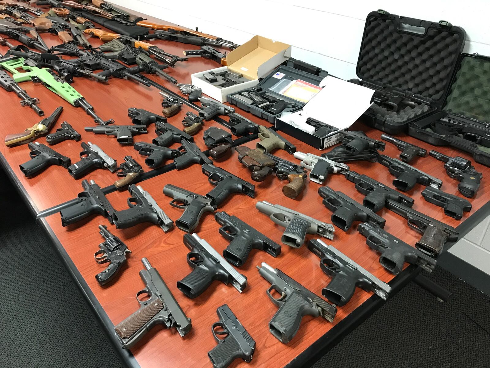 More that 100 firearms seized from a West Chester Twp. home displayed at the Butler County Sheriff’s Office. NICK GRAHAM/STAFF