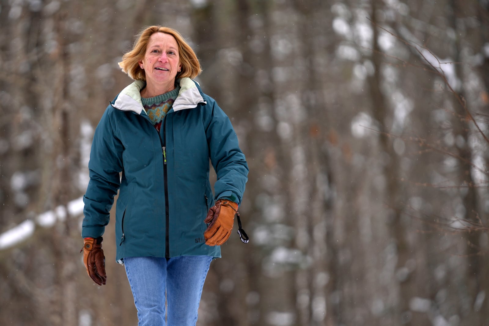 Judy Sandler, who was diagnosed in her 50s with ADHD, walks in the woods near her home, Thursday, Jan. 23, 2025, in Lincolnville, Maine.(AP Photo/Robert F. Bukaty)