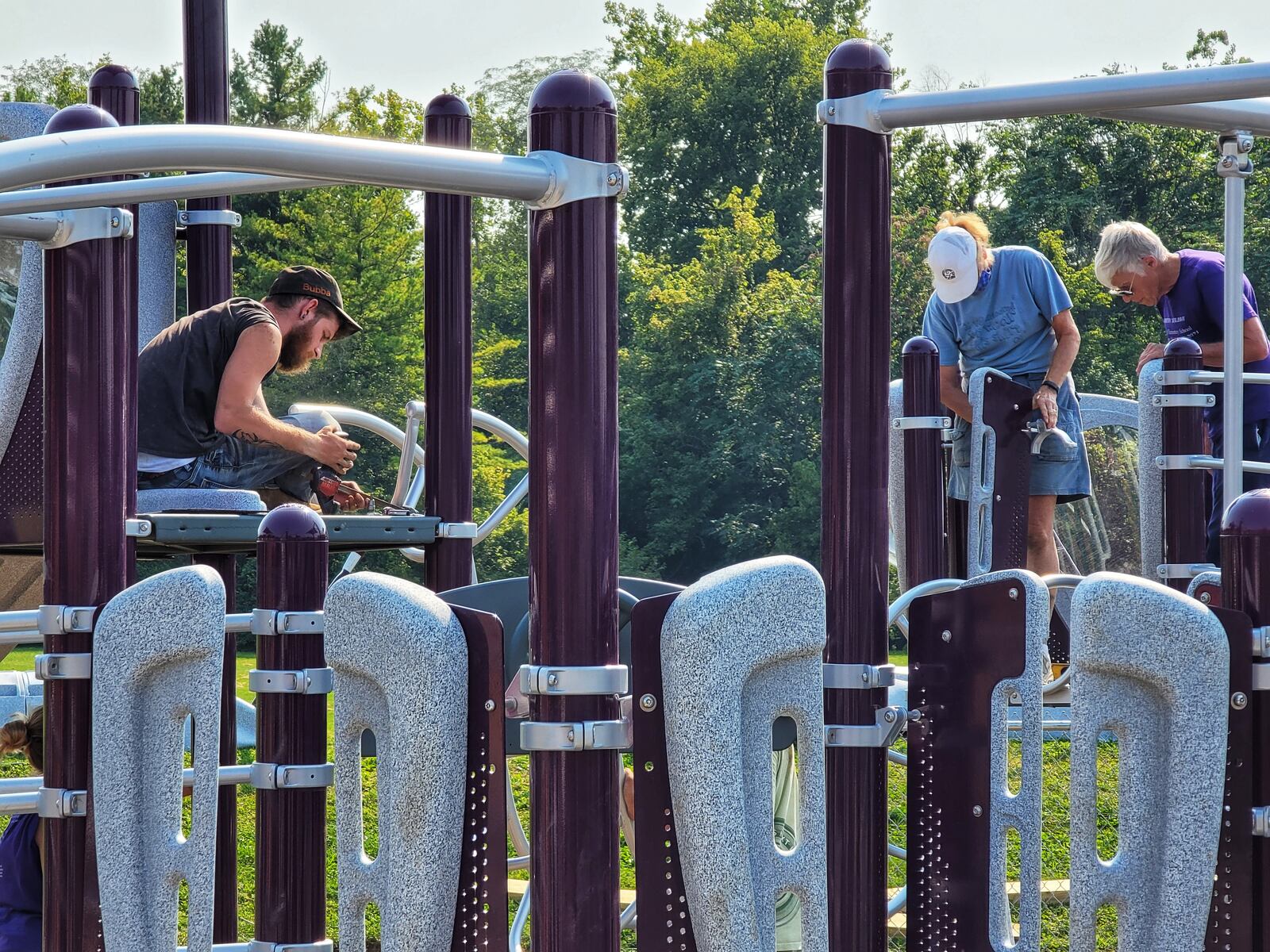 The playground at Amanda Elementary School on Oxford-State Road nears completion on Monday after four days of work from Middletown Kiwanis members and community volunteers. The playground will be named in memory of Guy Stone, a longtime Kiwanian and co-chair of the project who died this year. NICK GRAHAM/STAFF