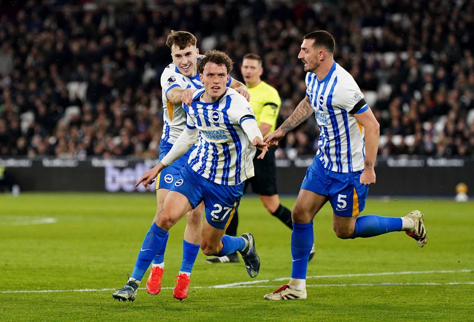 Brighton and Hove Albion's Mats Wieffer, center, celebrates scoring with teammates during the English Premier League soccer match between West Ham United and Brighton & Hove Albion at the London Stadium, London, Saturday Dec 21, 2024. (Ben Whitley/PA via AP)