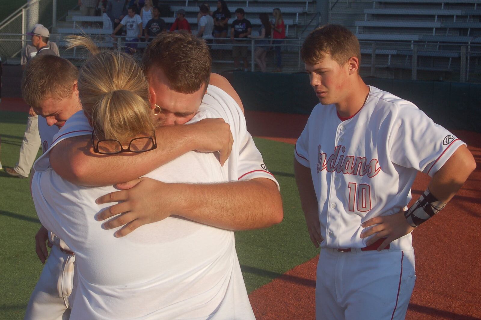 Carlisle’s Jake Glover hugs his mother after Friday’s 2-1 loss to Cincinnati Hills Christian Academy in a Division III regional final at the Athletes in Action complex in Xenia. Also emotional after the defeat was Bryce Gosney (10). CONTRIBUTED PHOTO BY JOHN CUMMINGS