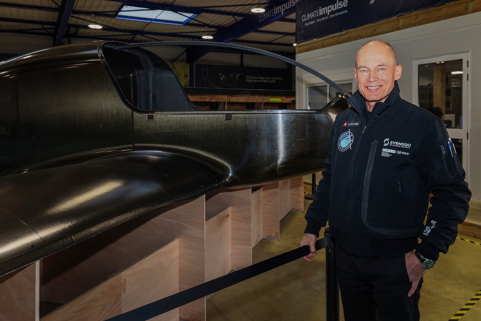 Swiss aviation pioneer Bertrand Piccard poses for a photo in front of the Climate Impulse, a plane powered by liquid hydrogen, at a hangar in Les Sables d'Olonne, France on Thursday, Feb. 13, 2025.(AP Photo/Yohan Bonnet)