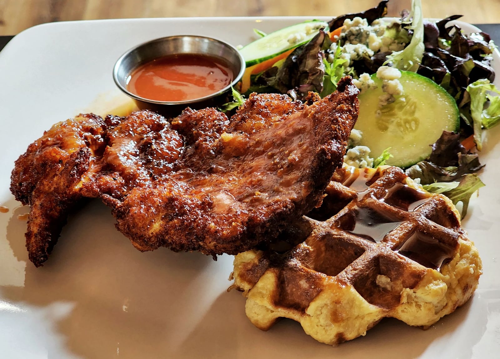 Taste of Belgium has opened at Liberty Center in Liberty Township. This is their chicken and waffle served with maple syrup and hot sauce. NICK GRAHAM/STAFF