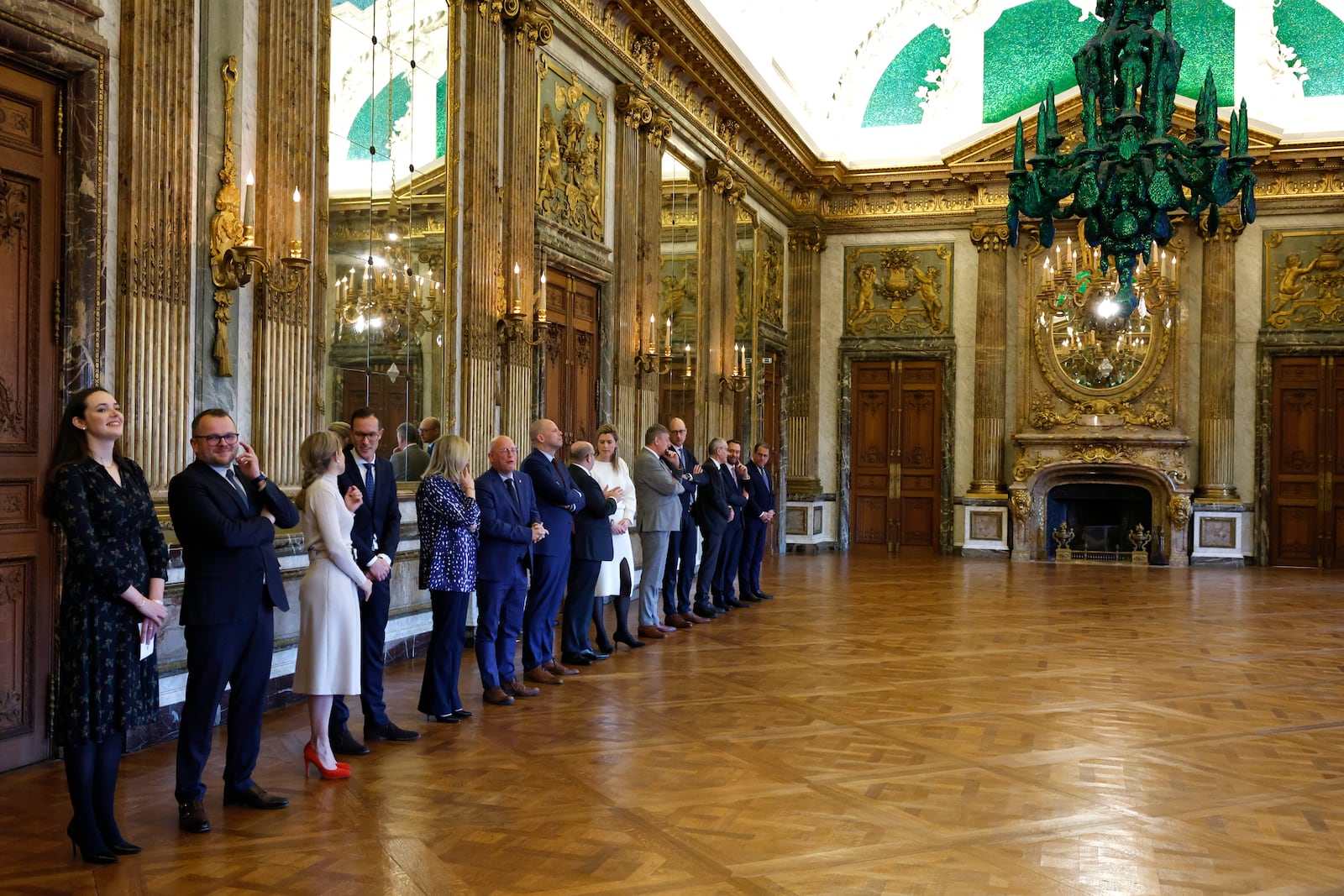 Government ministers stand in a line prior to a swearing in ceremony for the new Belgian government in front of Belgium's King Philippe at the Royal Palace in Brussels, Monday, Feb. 3, 2025. (AP Photo/Omar Havana)