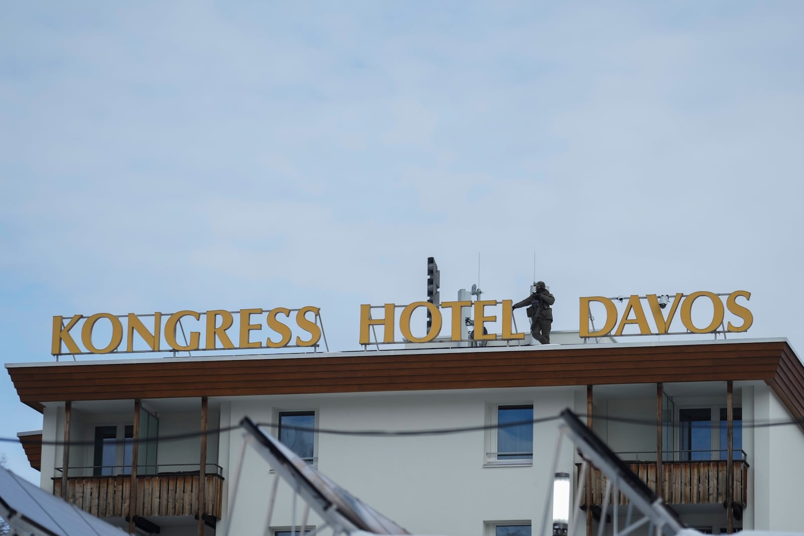 A police officer stands guards on the roof of the Congress Hotel on the final day at the World Economic Forum in Davos,Switzerland, Friday, Jan. 24, 2025. (AP Photo/Markus Schreiber)