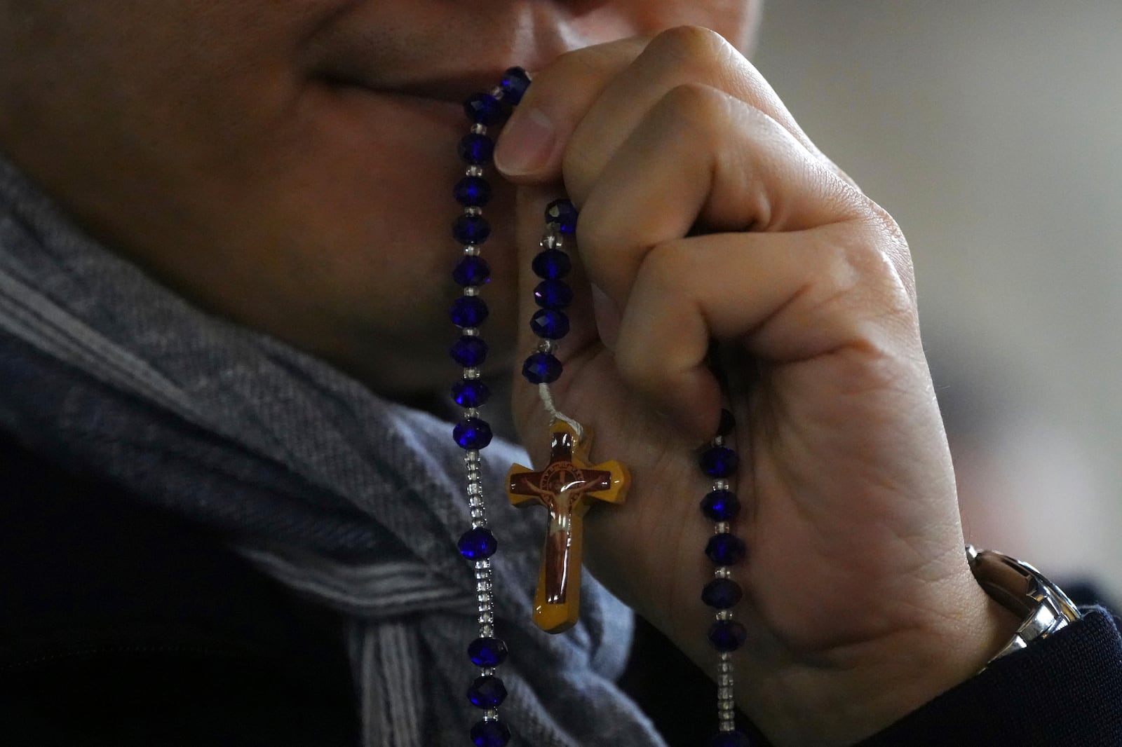 A man attends a rosary prayer service with Cardinal Luis Antonio Tagle held for the health of Pope Francis in St Peter's Square at The Vatican, Tuesday, Feb. 25, 2025. (AP Photo/Kirsty Wigglesworth)