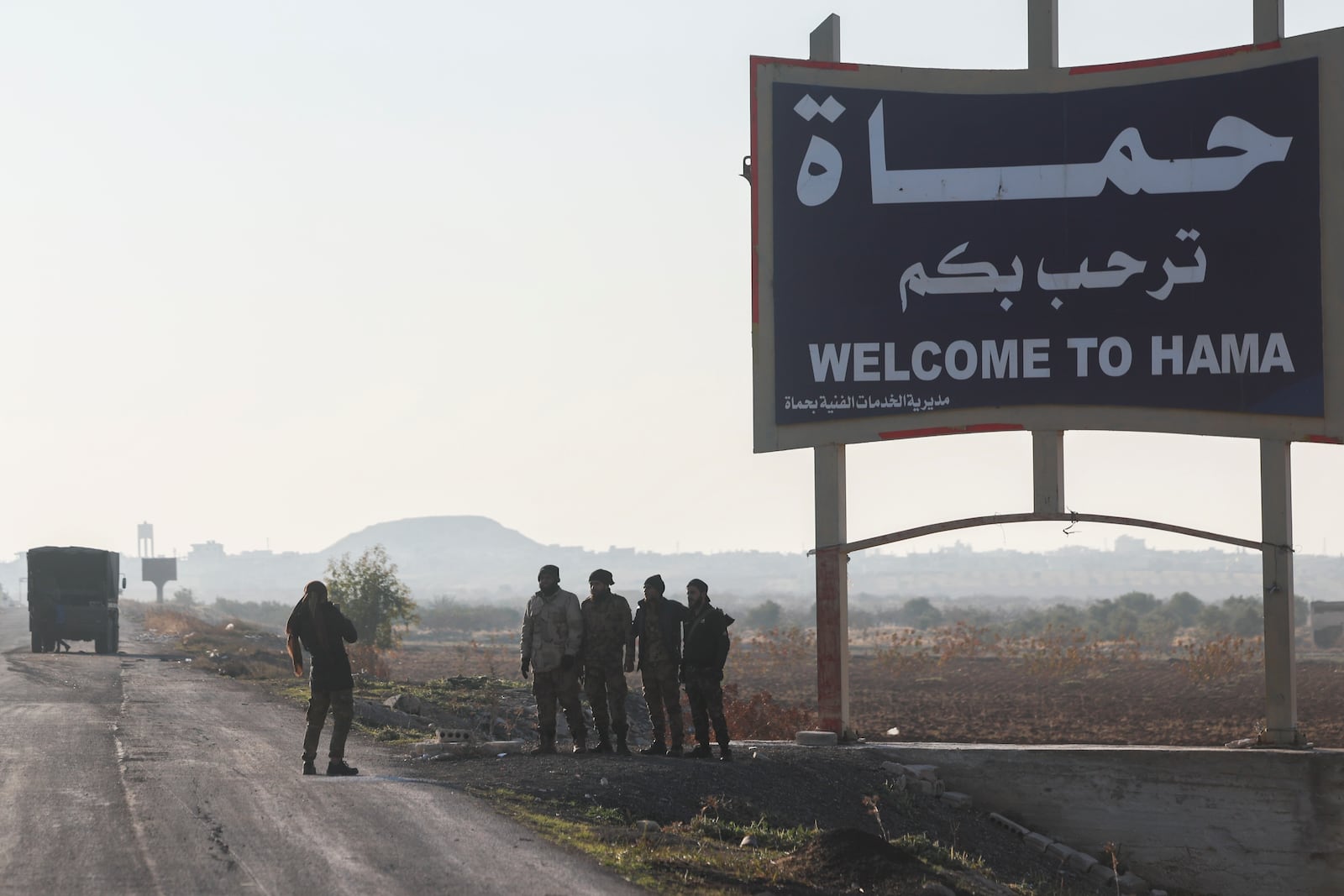 Syrian opposition fighters take pictures in the outskirts of of Hama, Syria, Tuesday Dec. 3, 2024.(AP Photo/Ghaith Alsayed)