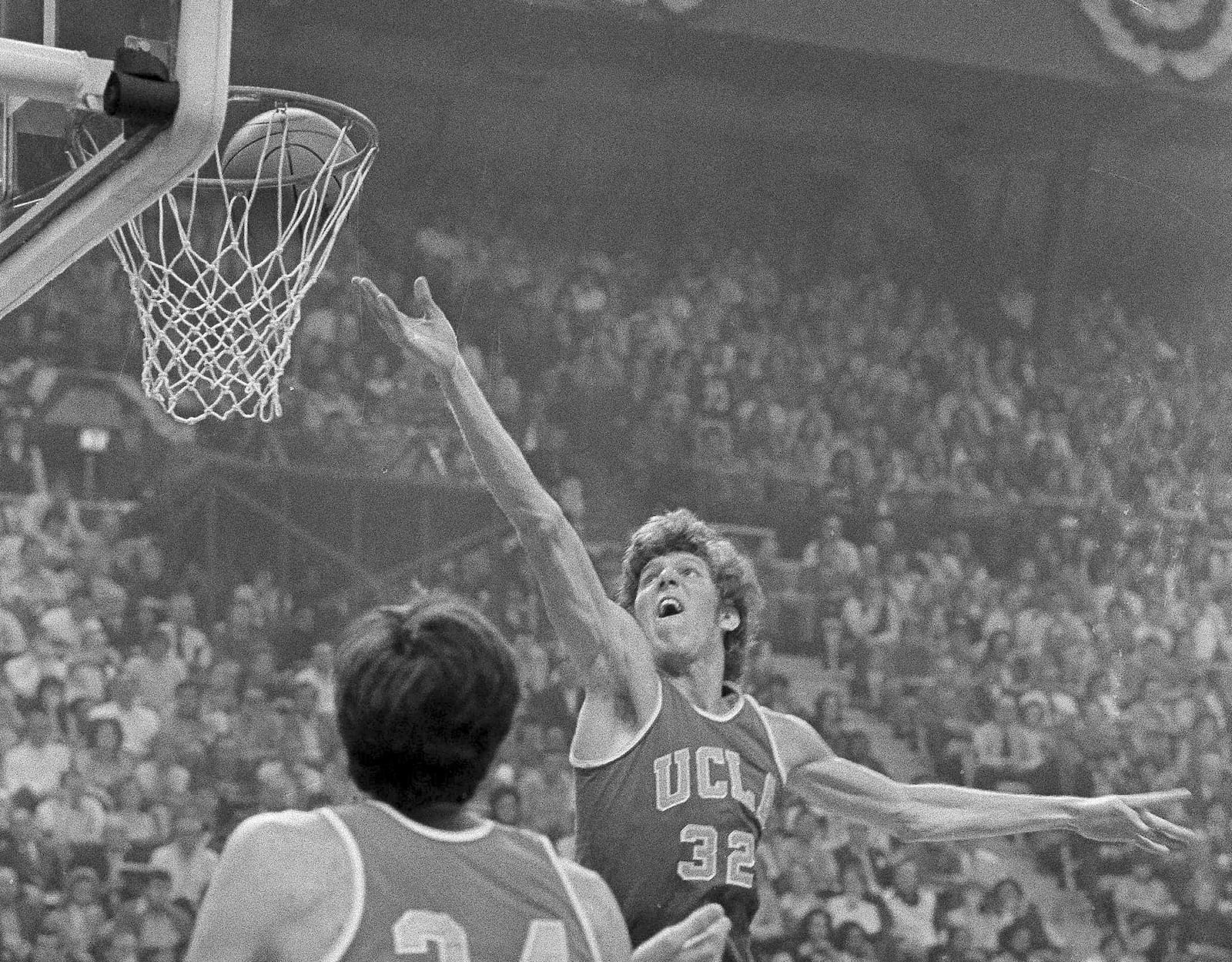 FILE - UCLA center Bill Walton goes to the basket against Indiana during the semifinal game of the Final Four NCAA college basketball championship in St. Louis, March 24, 1973. (AP Photo/File)